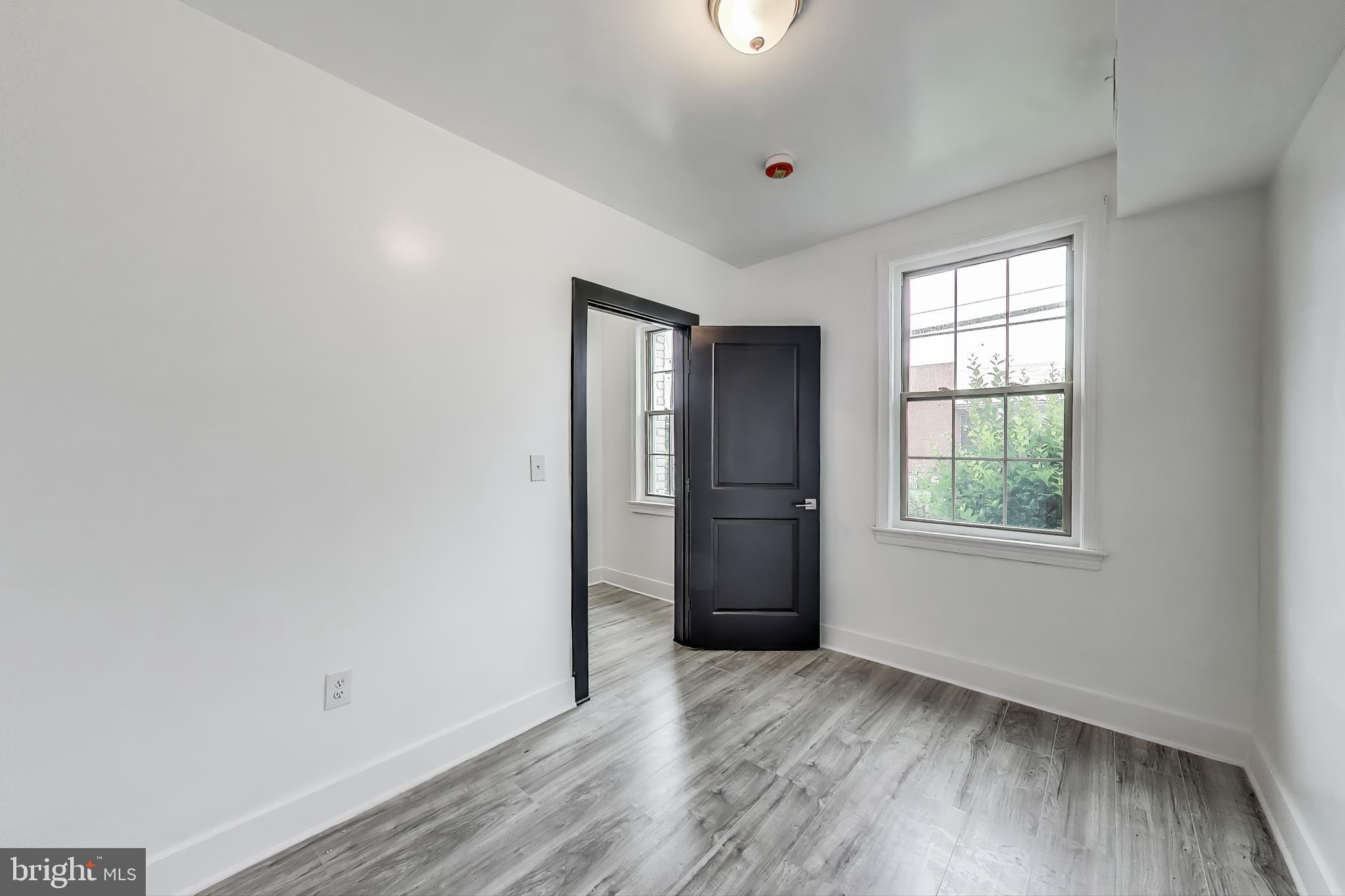 3918 10th Street Northeast, Unit 3 Washington, DC 20017 - Photo 11 of 69 an empty room with wooden floor and windows