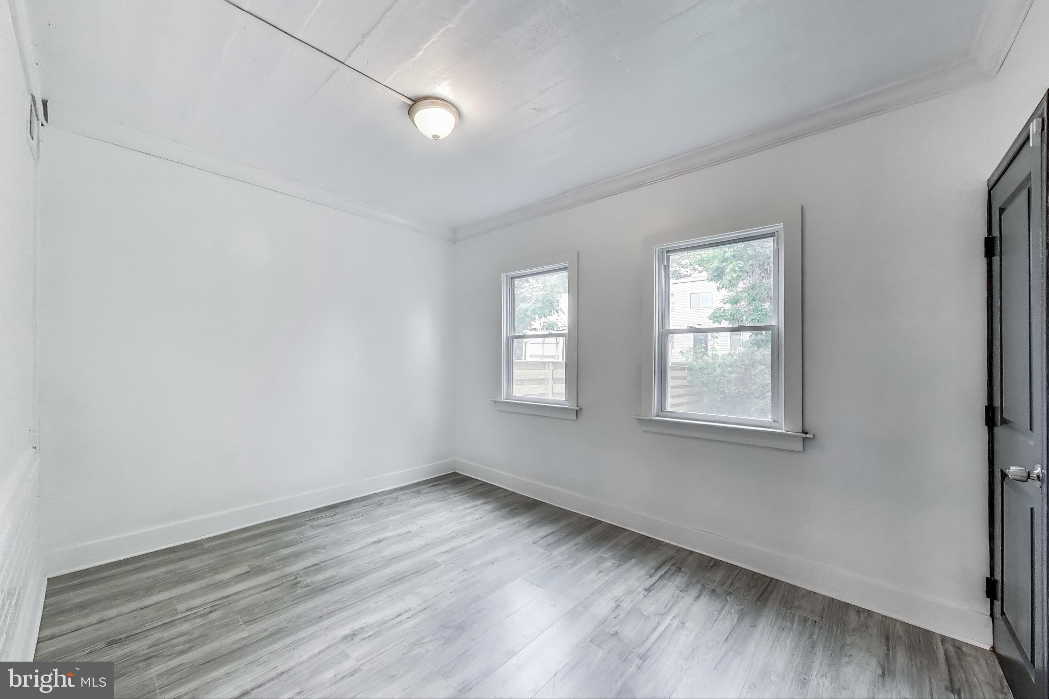3918 10th Street Northeast, Unit 3 Washington, DC 20017 - Photo 12 of 69 an empty room with wooden floor and windows