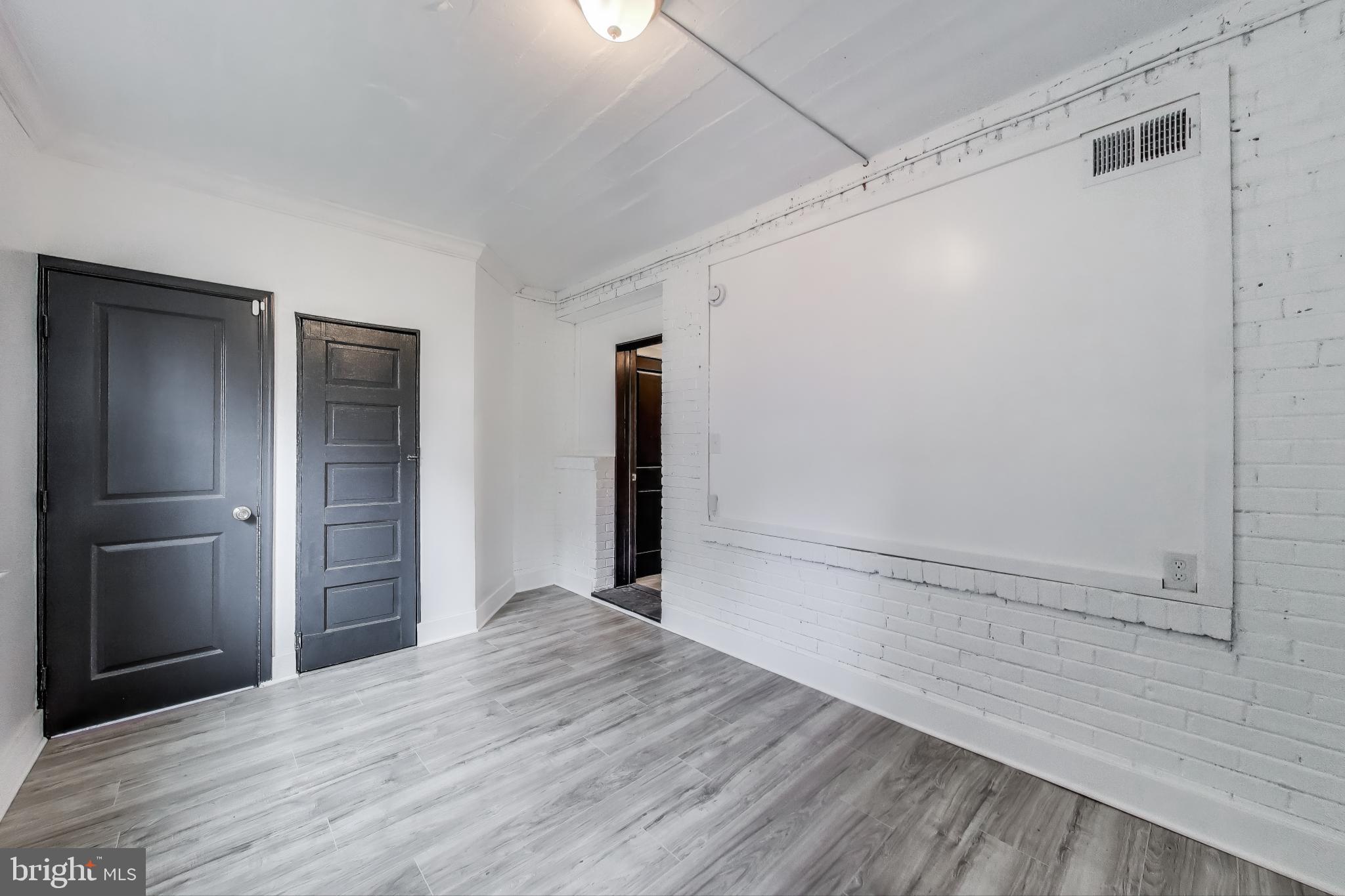 3918 10th Street Northeast, Unit 3 Washington, DC 20017 - Photo 14 of 69 a view of an empty room with wooden floor and closet