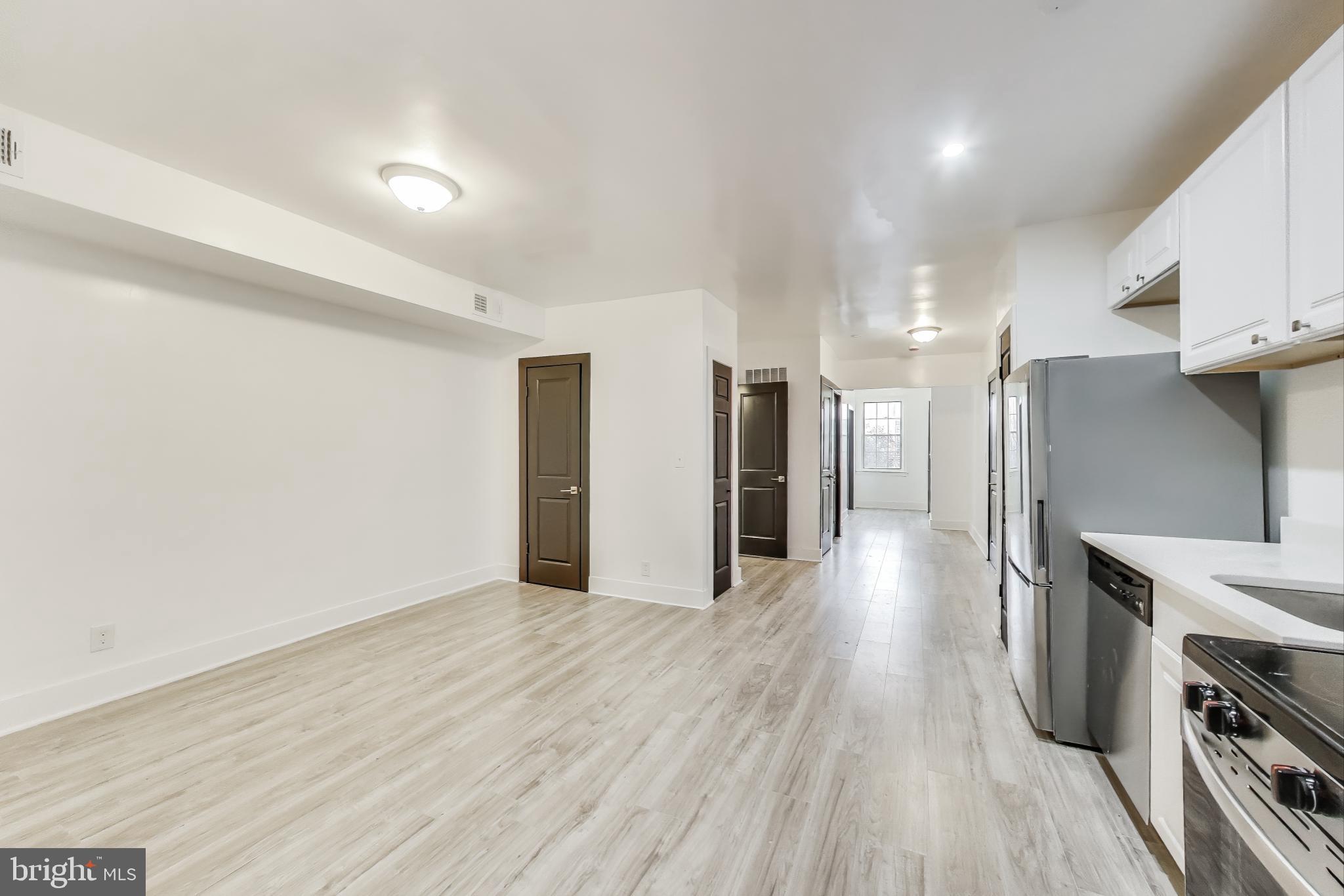 3918 10th Street Northeast, Unit 3 Washington, DC 20017 - Photo 21 of 69 a view of a kitchen with a fridge and wooden floor