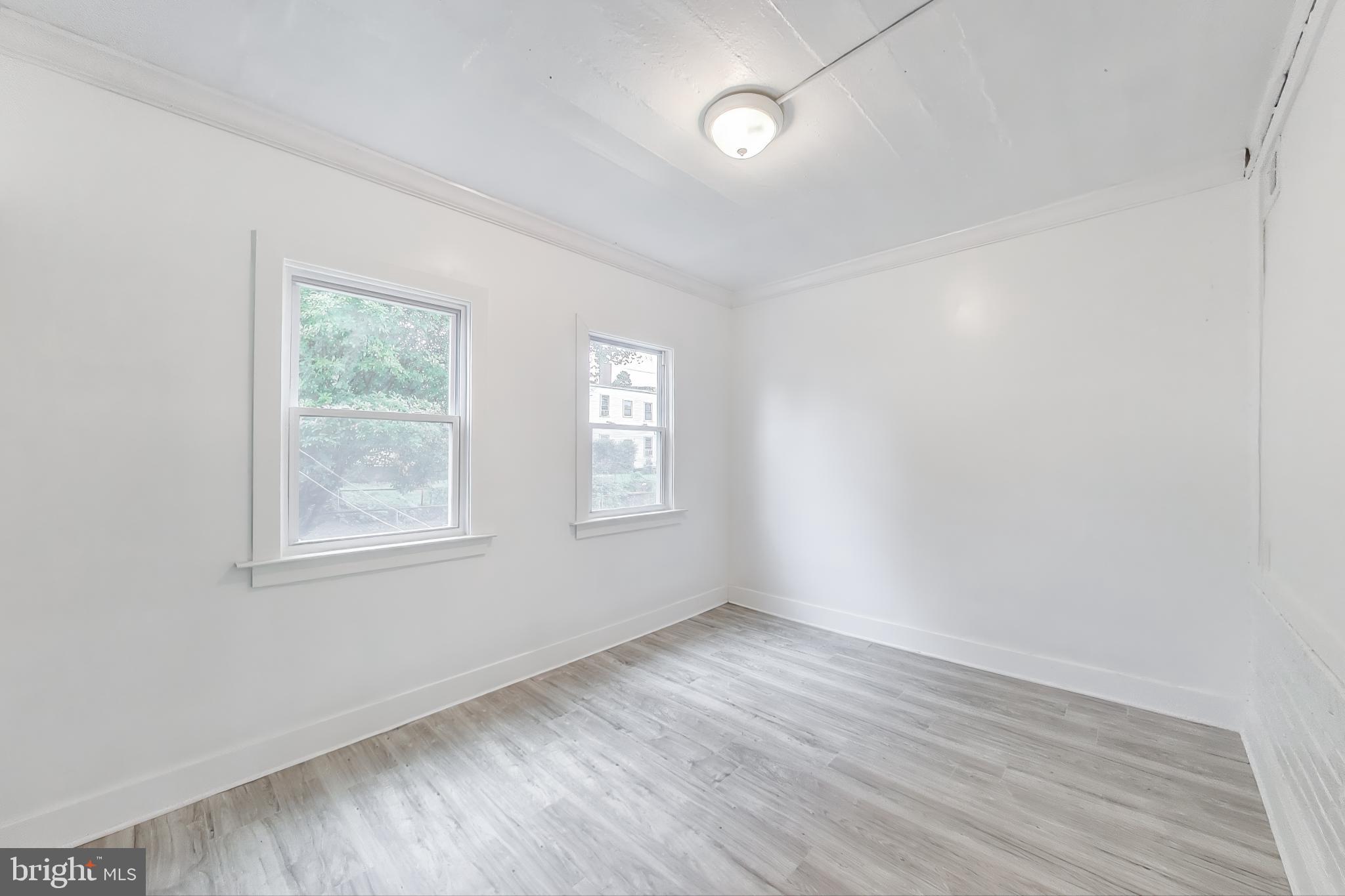 3918 10th Street Northeast, Unit 3 Washington, DC 20017 - Photo 28 of 69 an empty room with wooden floor and windows