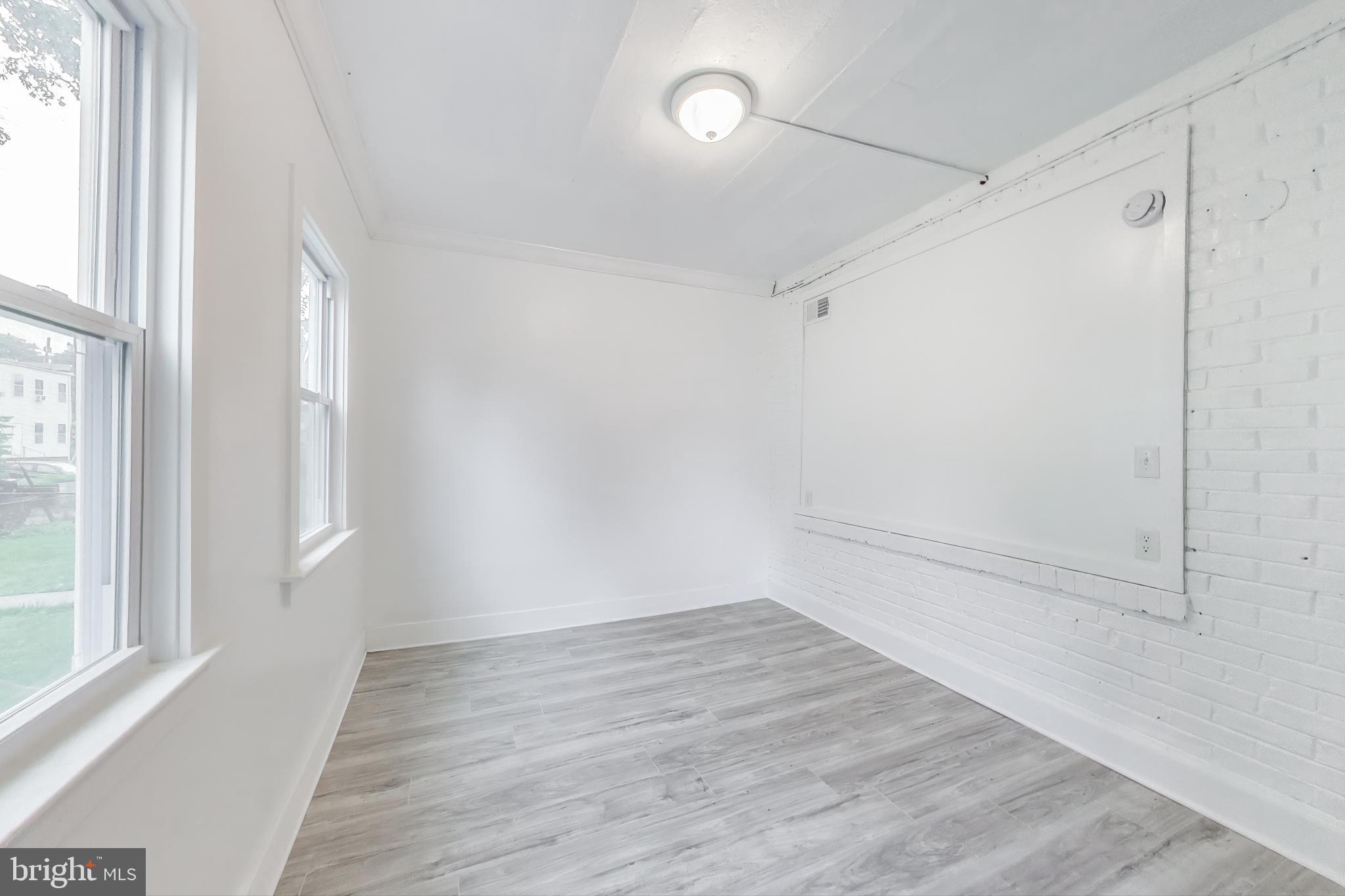 3918 10th Street Northeast, Unit 3 Washington, DC 20017 - Photo 29 of 69 a view of an empty room with wooden floor and a window