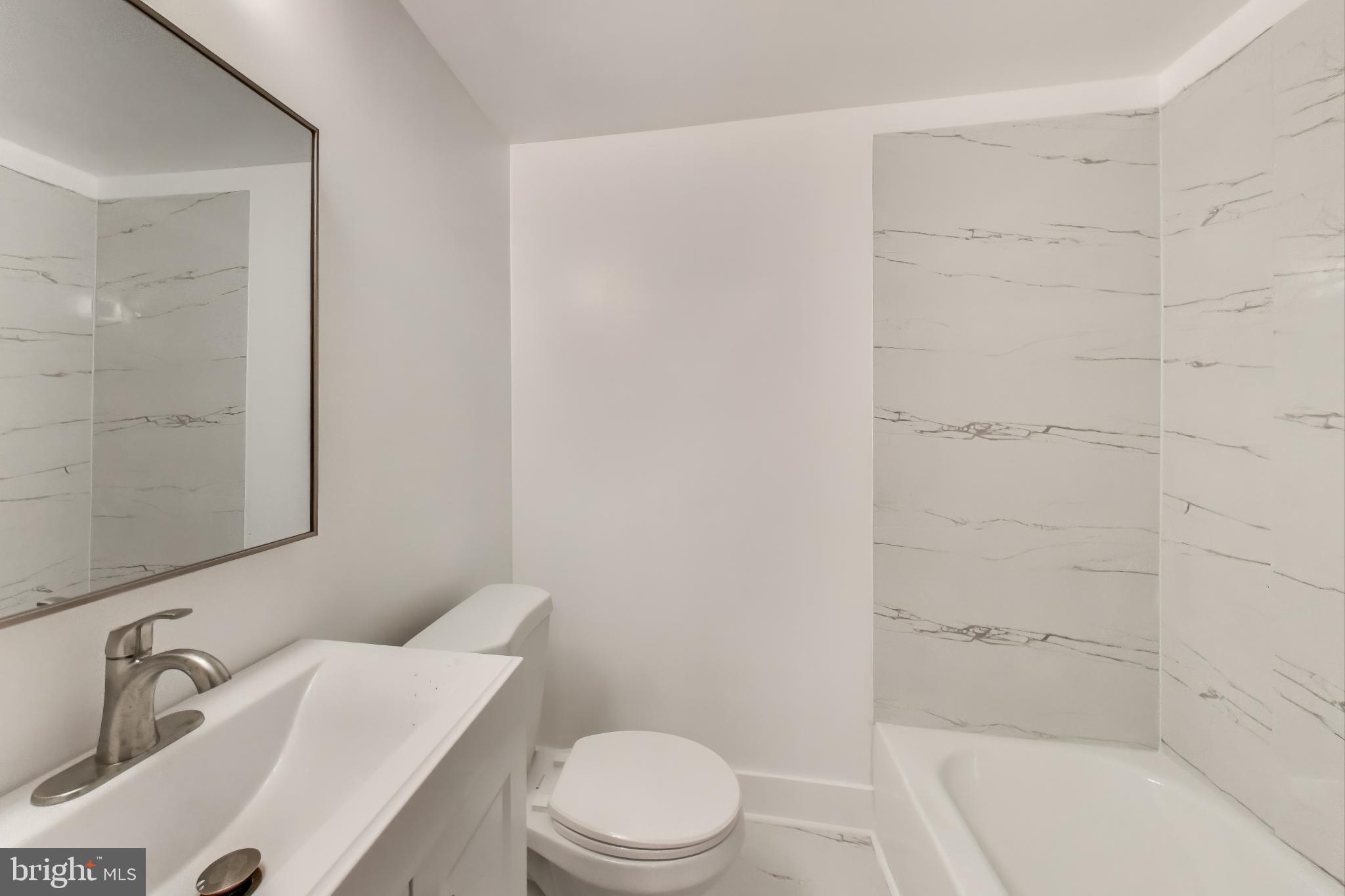 3918 10th Street Northeast, Unit 3 Washington, DC 20017 - Photo 31 of 69 a bathroom with a sink a toilet and shower