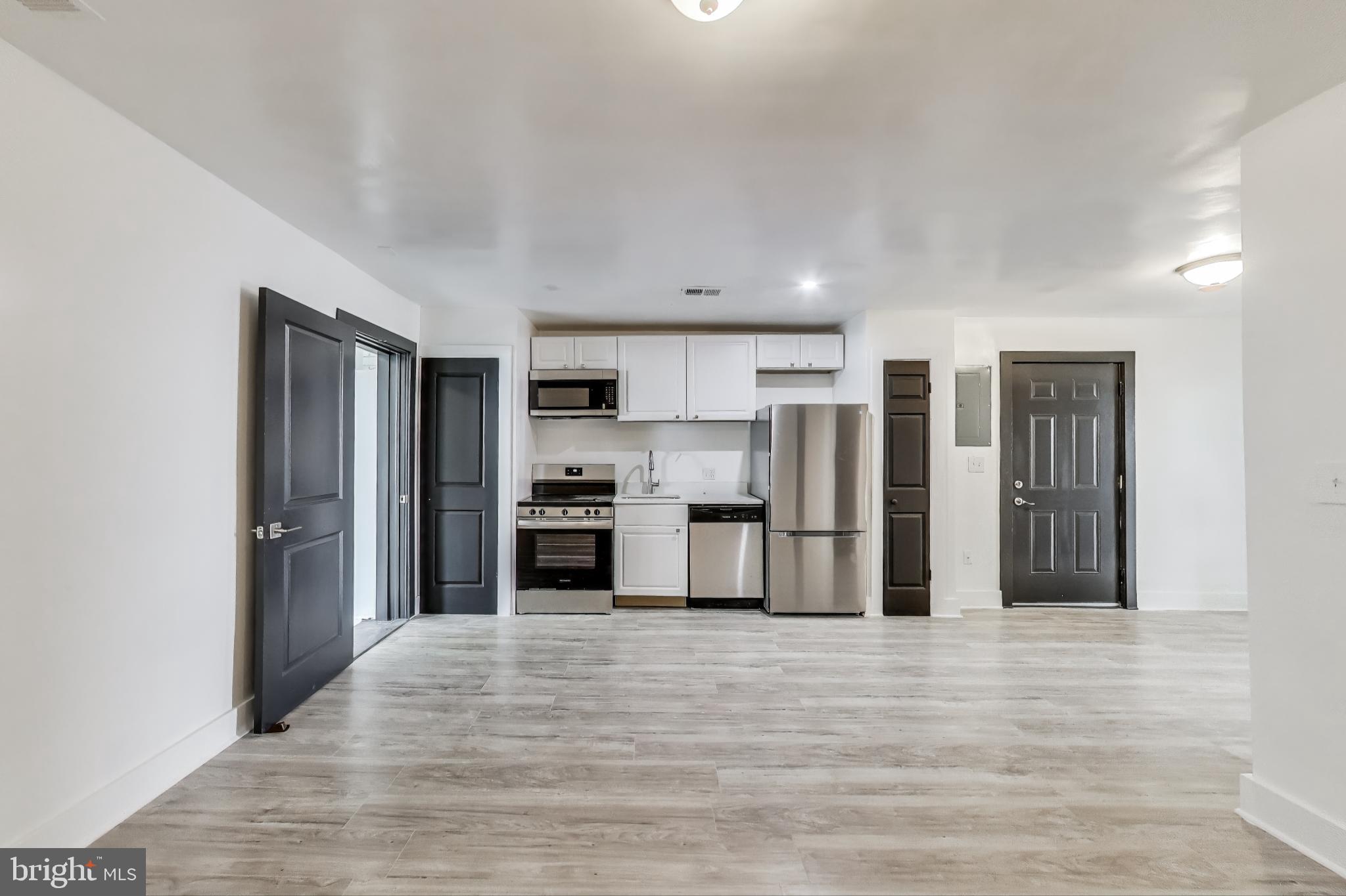 3918 10th Street Northeast, Unit 3 Washington, DC 20017 - Photo 37 of 69 a kitchen with stainless steel appliances kitchen island granite countertop a refrigerator and a stove top oven