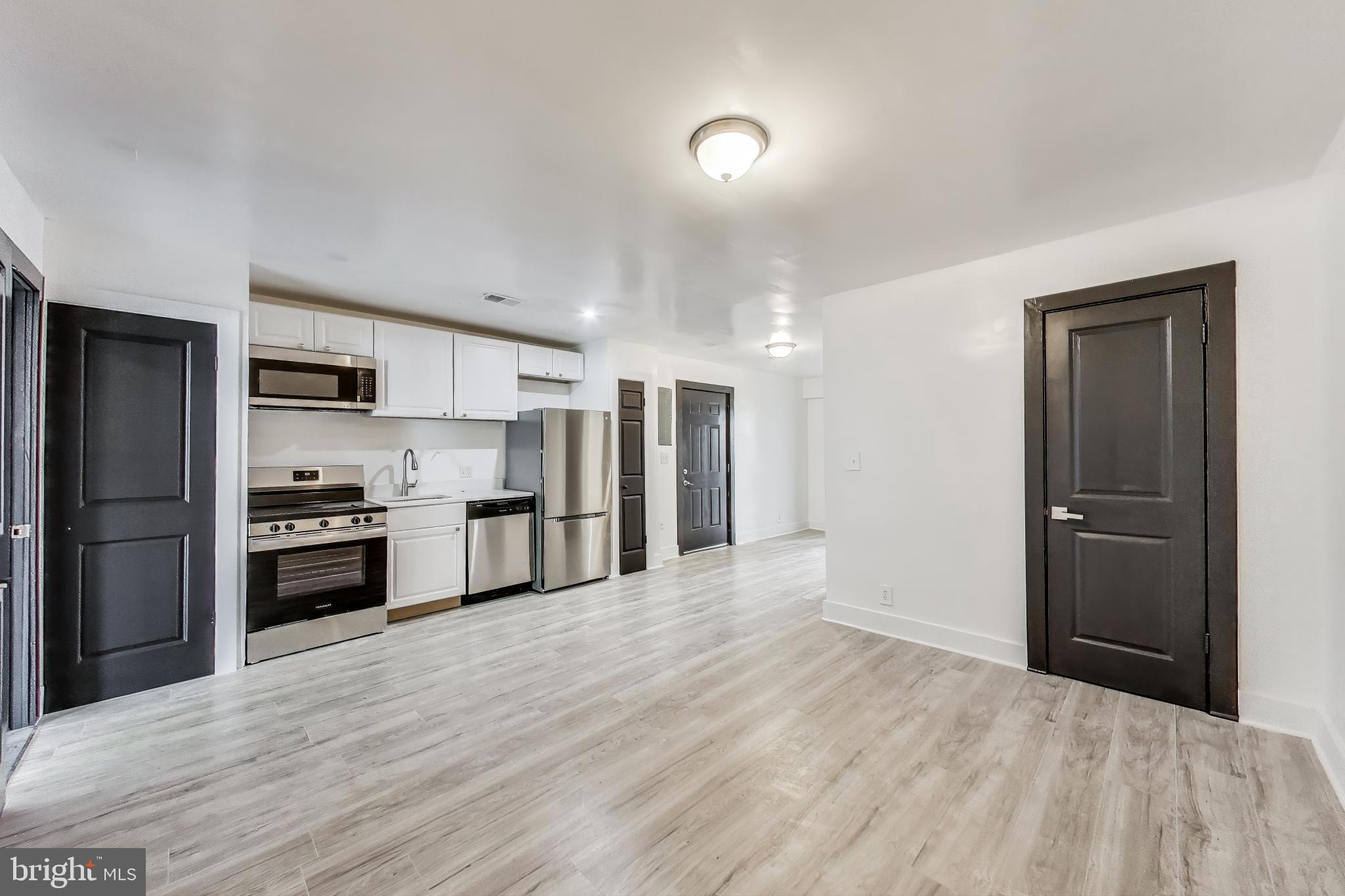 3918 10th Street Northeast, Unit 3 Washington, DC 20017 - Photo 38 of 69 a large kitchen with a refrigerator and a stove top oven