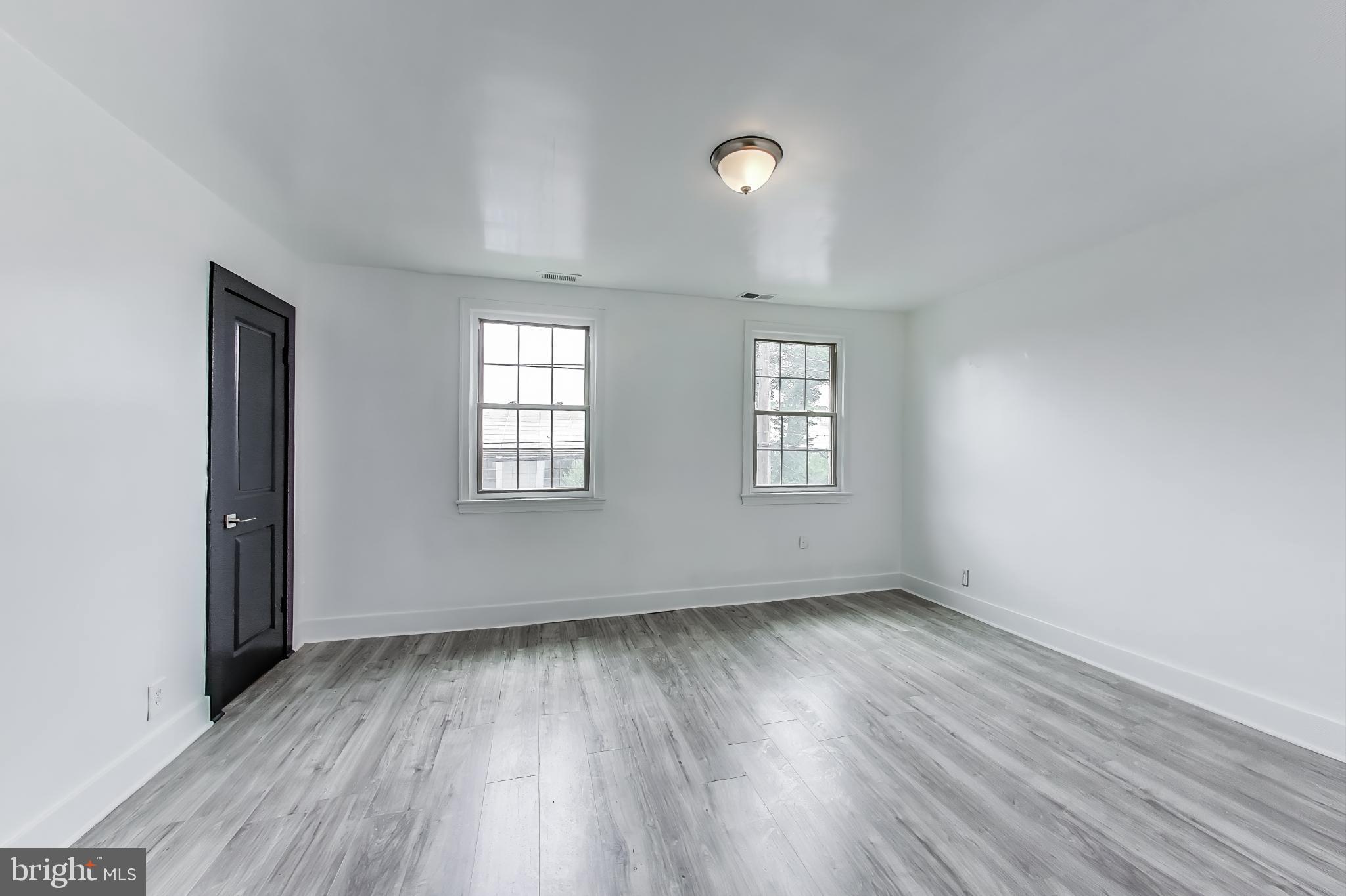 3918 10th Street Northeast, Unit 3 Washington, DC 20017 - Photo 41 of 69 an empty room with wooden floor and windows
