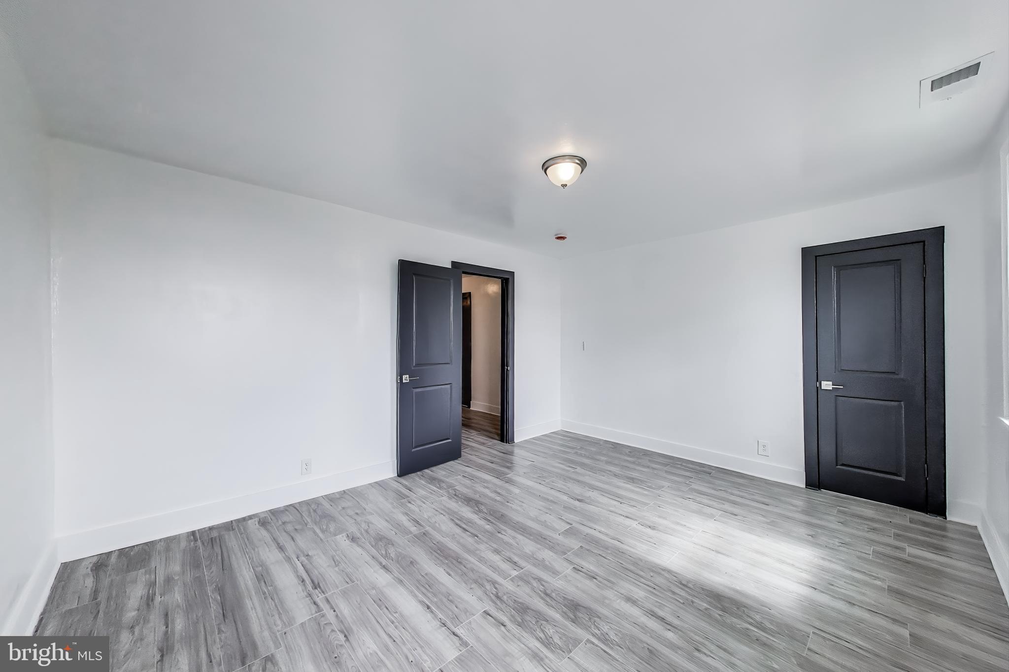 3918 10th Street Northeast, Unit 3 Washington, DC 20017 - Photo 42 of 69 a view of an empty room with wooden floor and closet