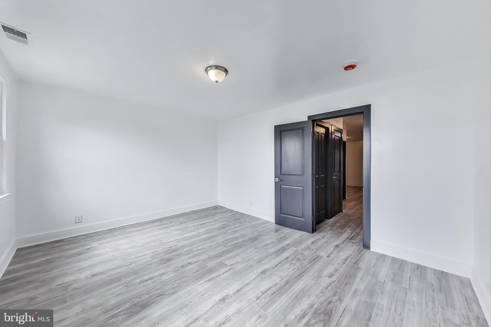 3918 10th Street Northeast, Unit 3 Washington, DC 20017 - Photo 43 of 69 a view of an empty room with wooden floor and closet