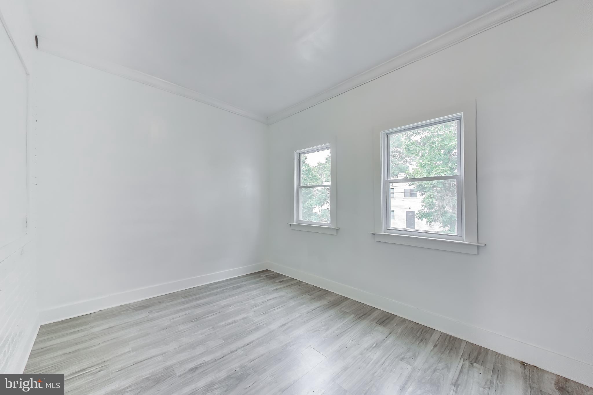 3918 10th Street Northeast, Unit 3 Washington, DC 20017 - Photo 44 of 69 an empty room with wooden floor and windows