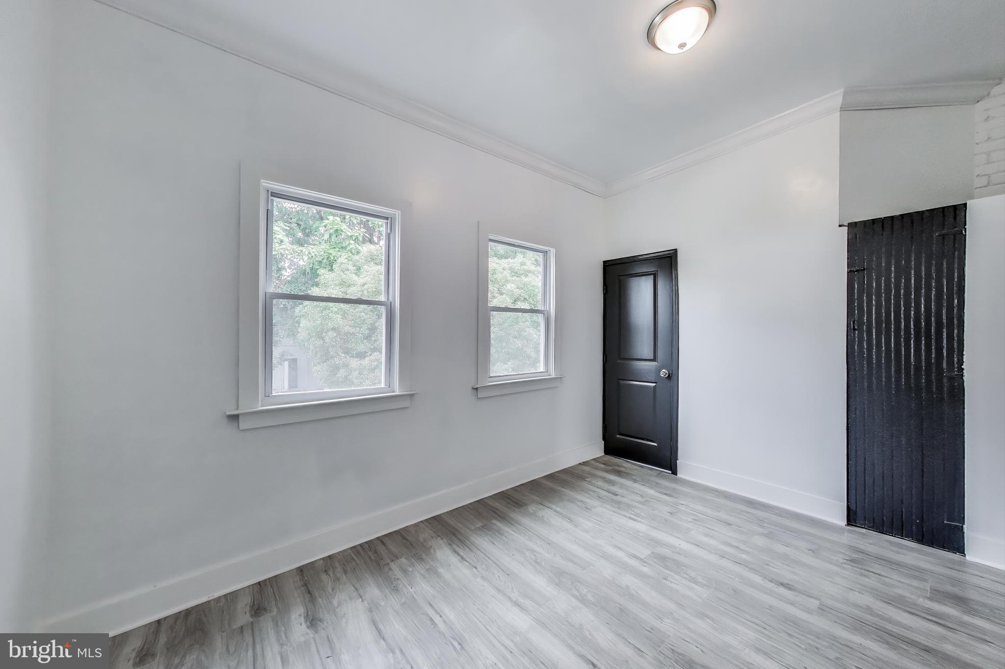 3918 10th Street Northeast, Unit 3 Washington, DC 20017 - Photo 45 of 69 an empty room with wooden floor and windows