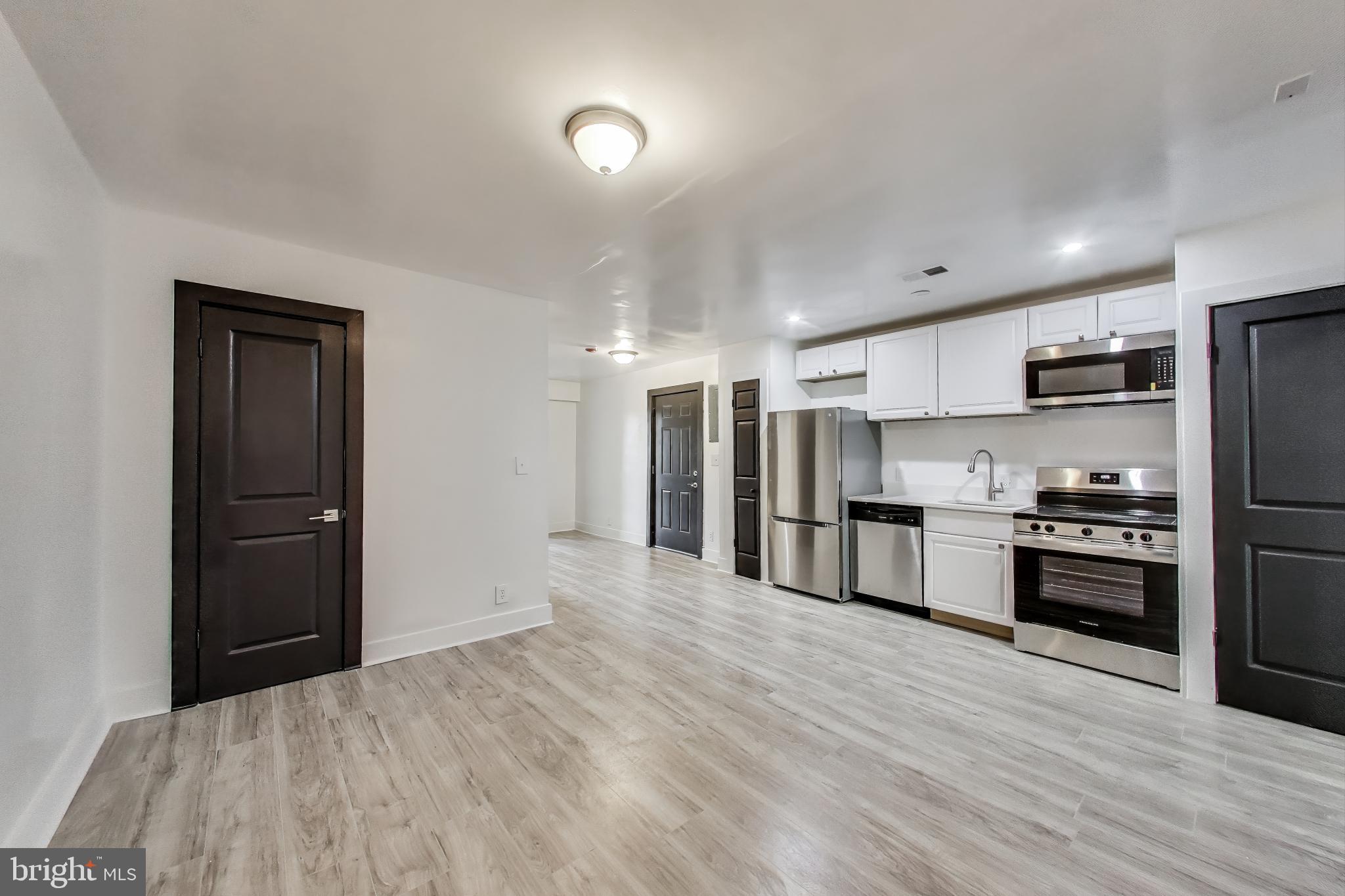 3918 10th Street Northeast, Unit 3 Washington, DC 20017 - Photo 54 of 69 a kitchen with stainless steel appliances kitchen island granite countertop a refrigerator and a stove top oven
