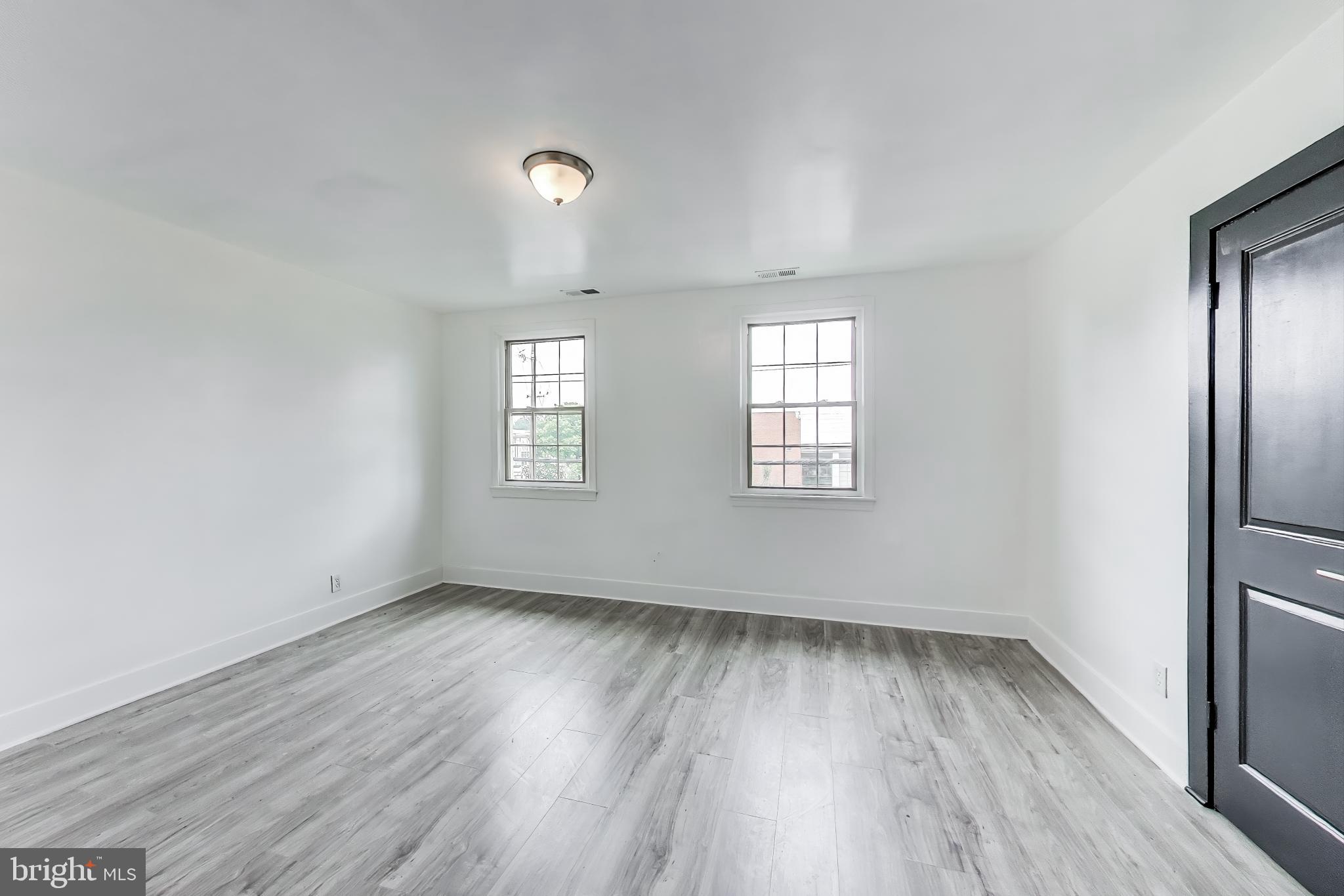 3918 10th Street Northeast, Unit 3 Washington, DC 20017 - Photo 56 of 69 an empty room with wooden floor and windows