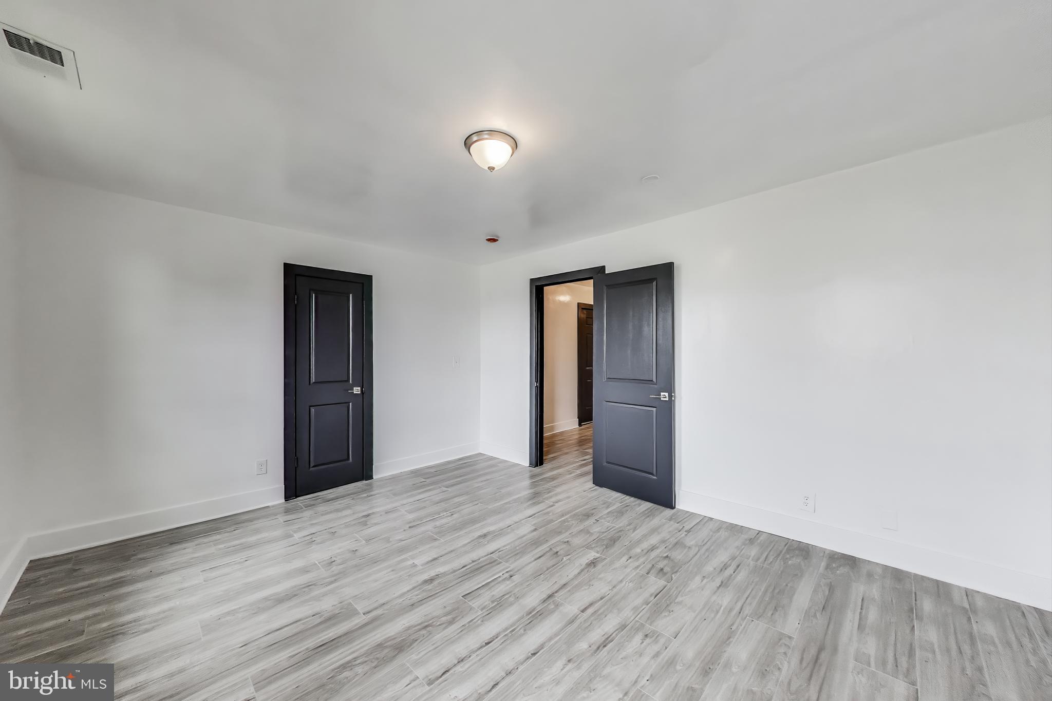 3918 10th Street Northeast, Unit 3 Washington, DC 20017 - Photo 57 of 69 a view of an empty room with wooden floor and closet