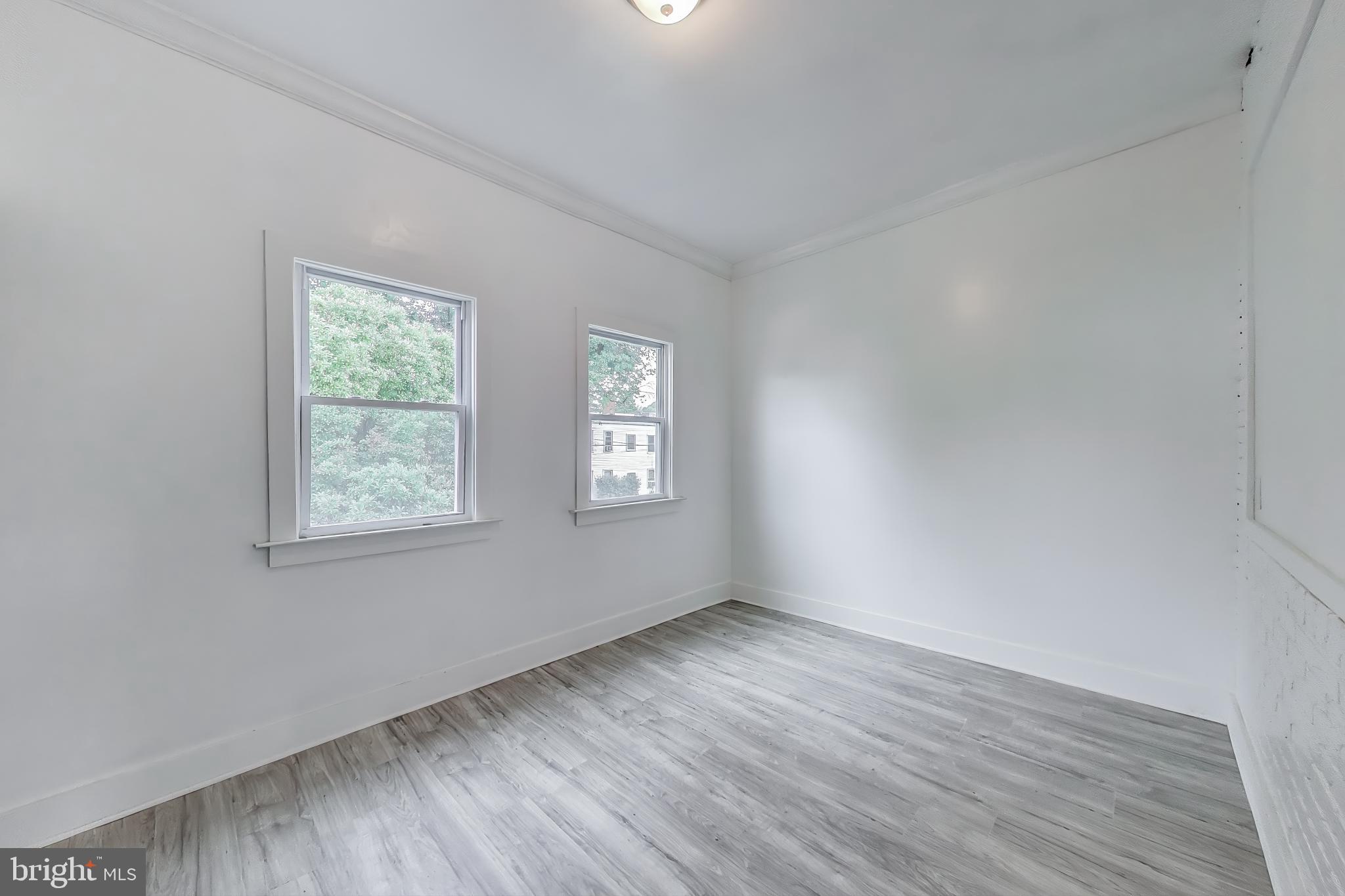 3918 10th Street Northeast, Unit 3 Washington, DC 20017 - Photo 59 of 69 an empty room with wooden floor and windows