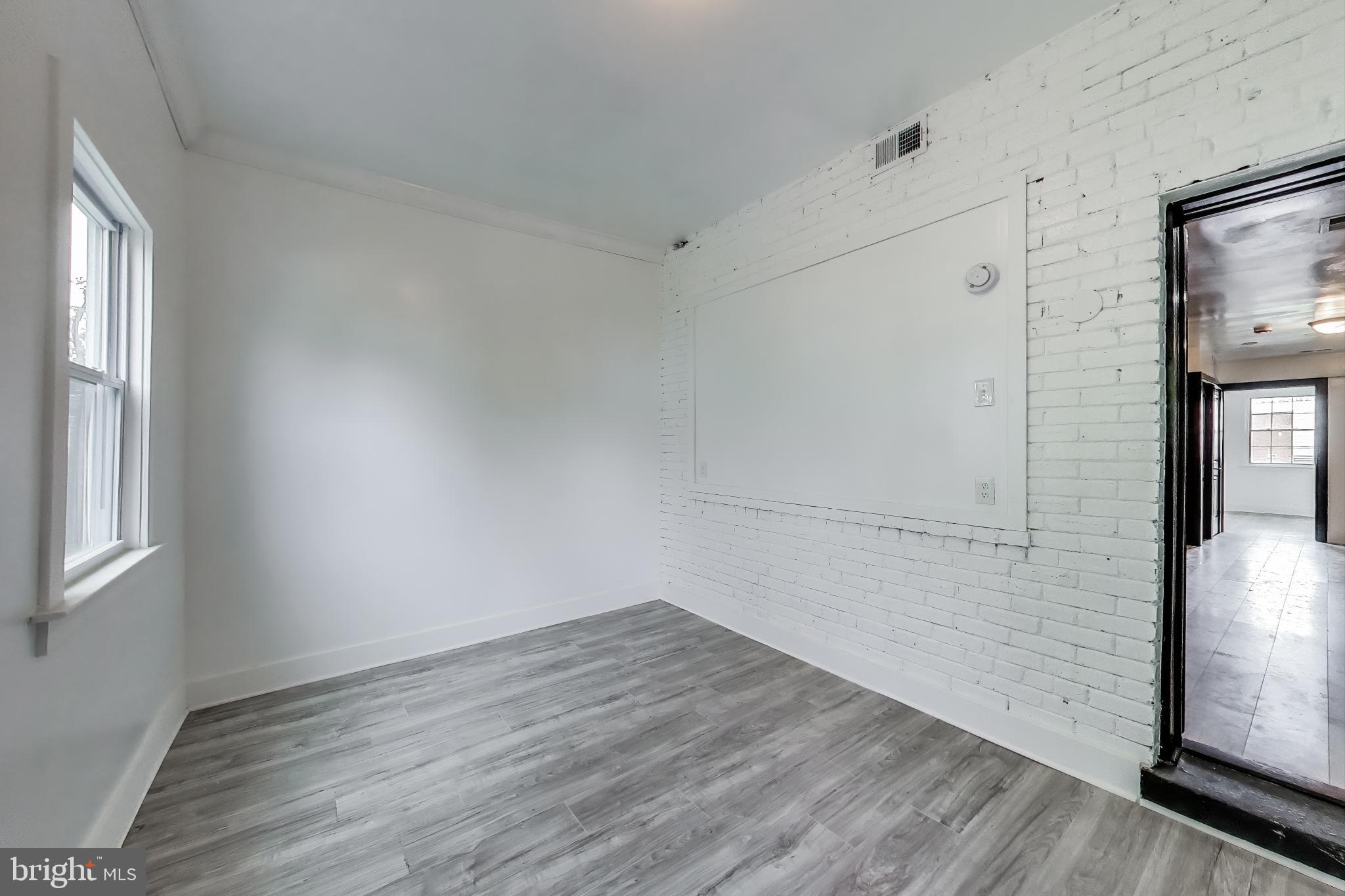 3918 10th Street Northeast, Unit 3 Washington, DC 20017 - Photo 61 of 69 a view of a room with wooden floor and windows