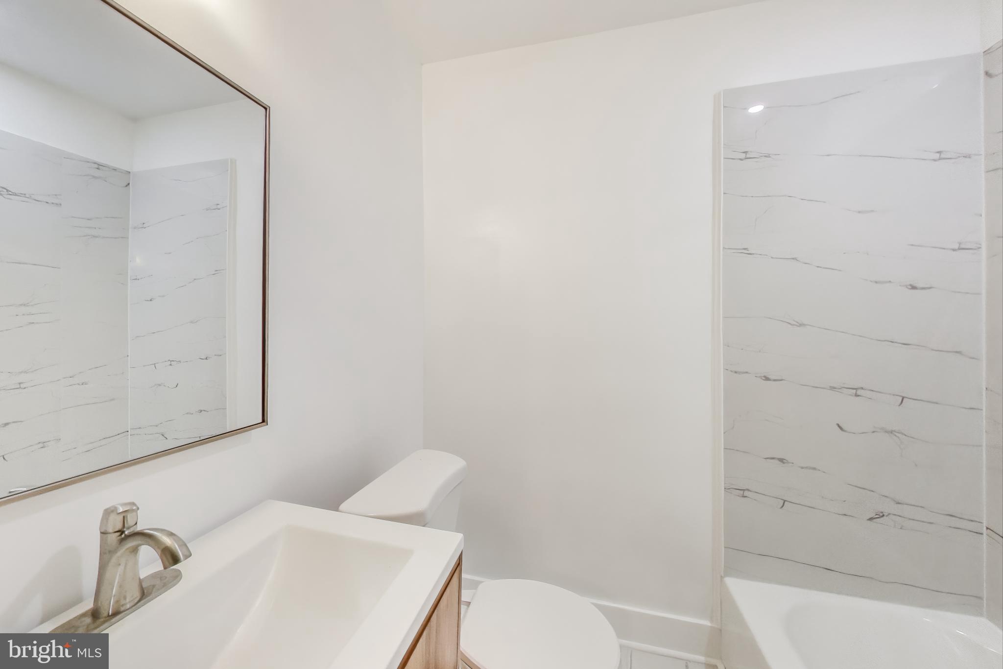 3918 10th Street Northeast, Unit 3 Washington, DC 20017 - Photo 62 of 69 a white toilet sitting next to a bathroom sink