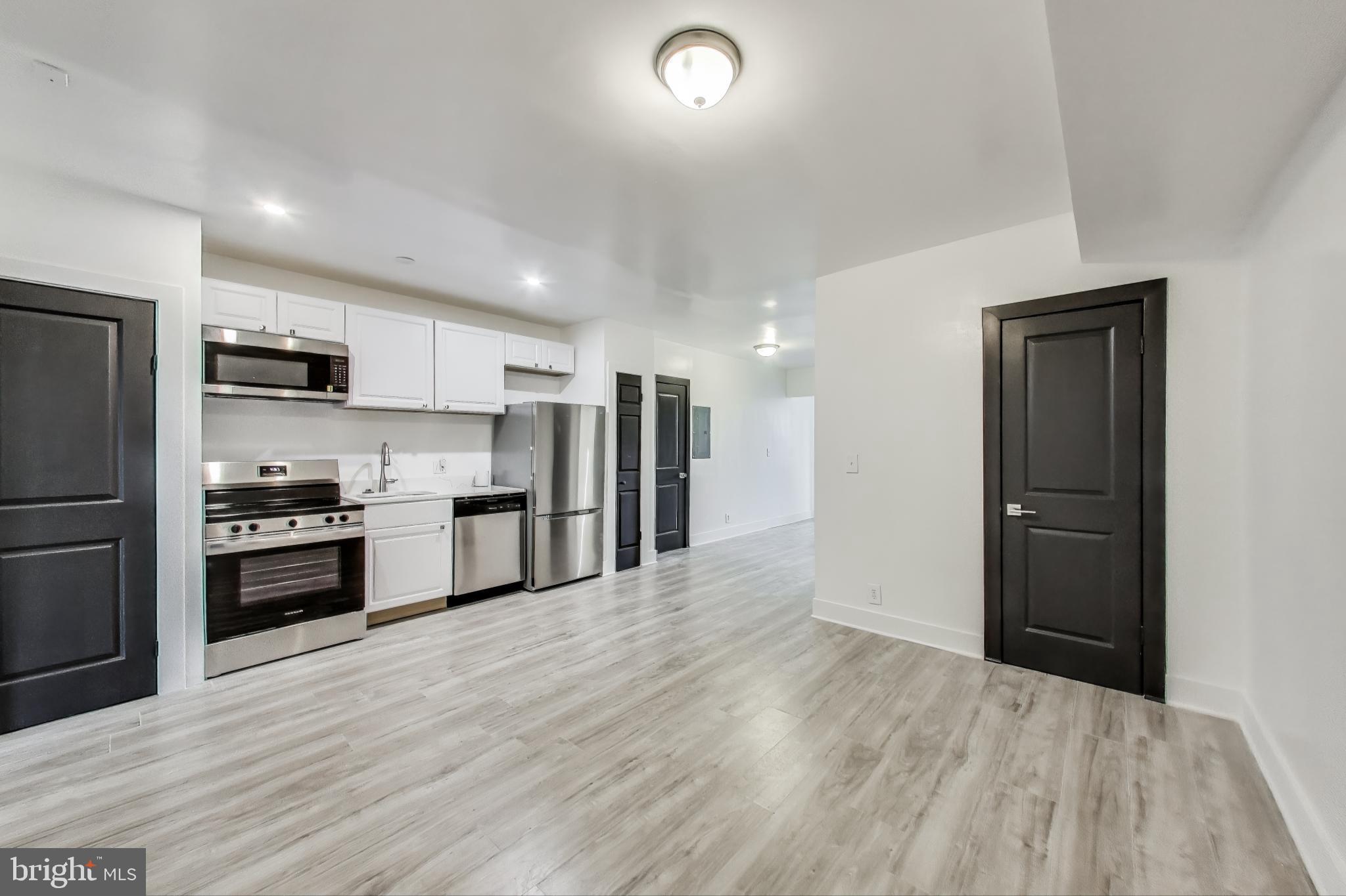3918 10th Street Northeast, Unit 3 Washington, DC 20017 - Photo 7 of 69 a kitchen with stainless steel appliances a refrigerator and a stove top oven