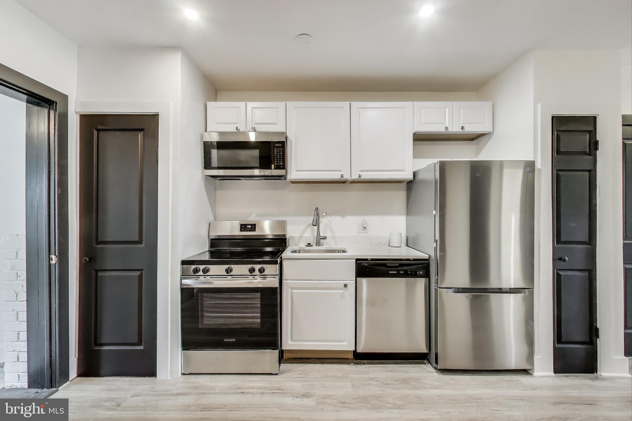 3918 10th Street Northeast, Unit 3 Washington, DC 20017 - Photo 8 of 69 a kitchen with stainless steel appliances a refrigerator a stove and a sink