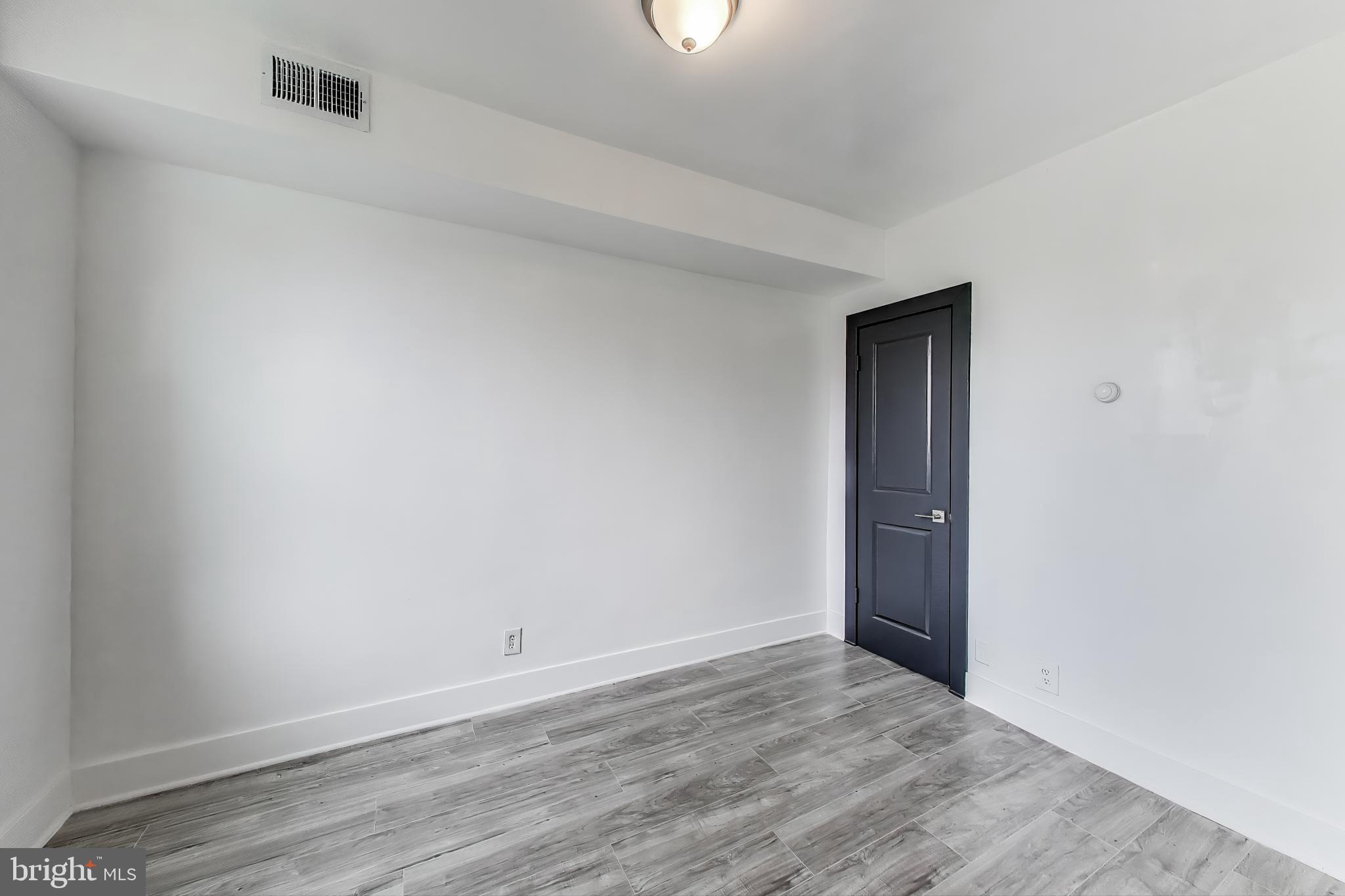 3918 10th Street Northeast, Unit 3 Washington, DC 20017 - Photo 9 of 69 a view of an empty room and wooden floor