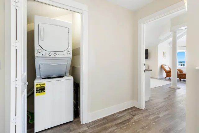 a aerial view of a house with swimming pool lawn chairs and potted plants