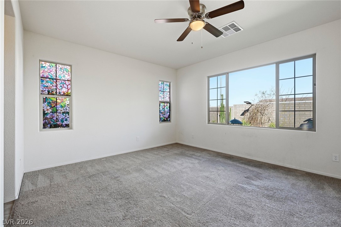 250 Dedication Avenue Henderson, NV 89011 - Photo 20 of 67 Carpeted spare room featuring plenty of natural light and ceiling fan