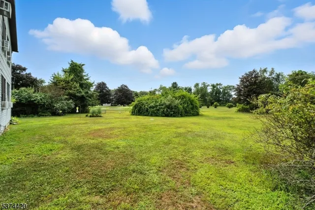 a view of a green field with wooden fence