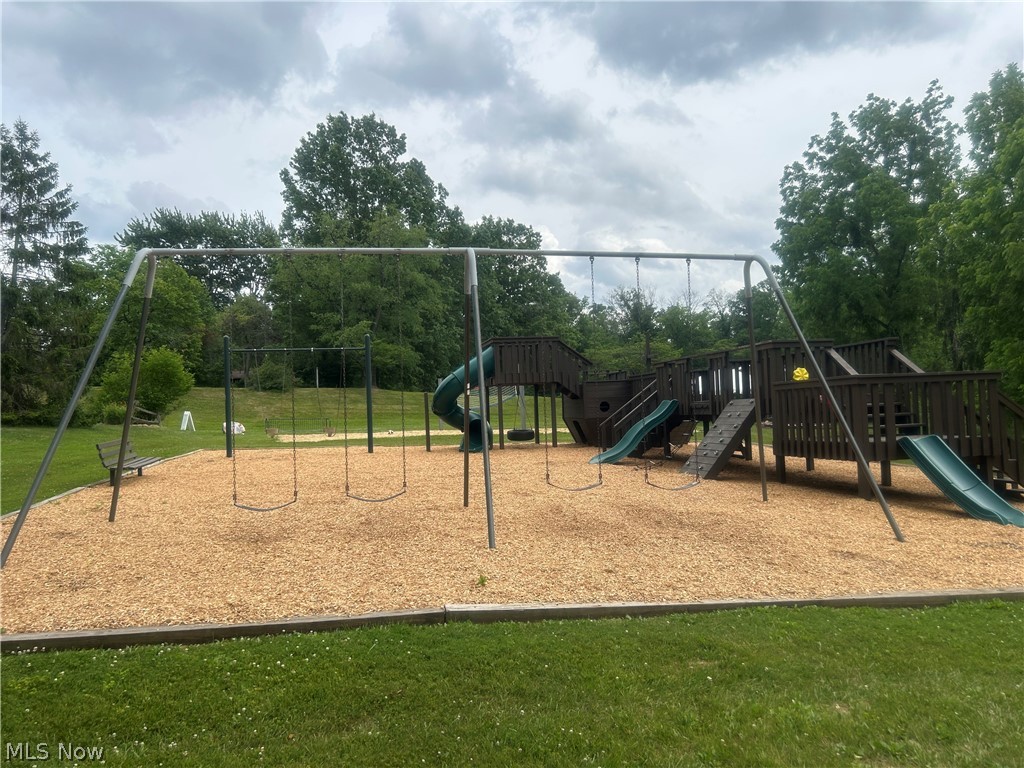 824 South Chillicothe Road, Unit 2 Aurora, OH 44202 - Photo 41 of 42 Outdoor play structure featuring multiple slides, climbing elements, and a swing set