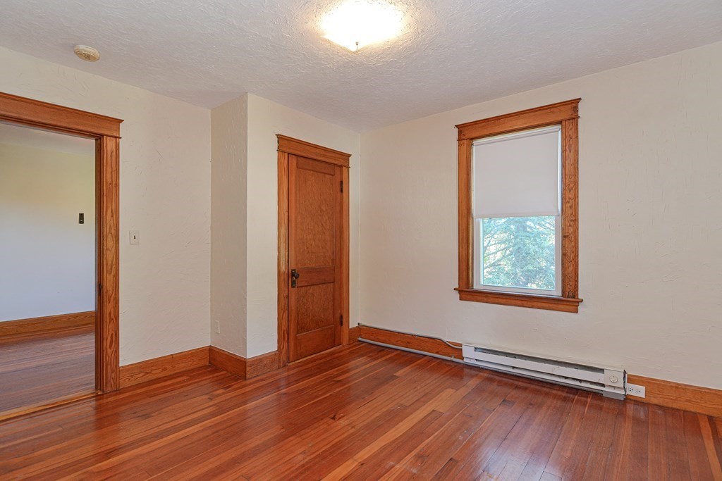 342 Providence Road Grafton, MA 01560 - Photo 14 of 40 an empty room with wooden floor and windows