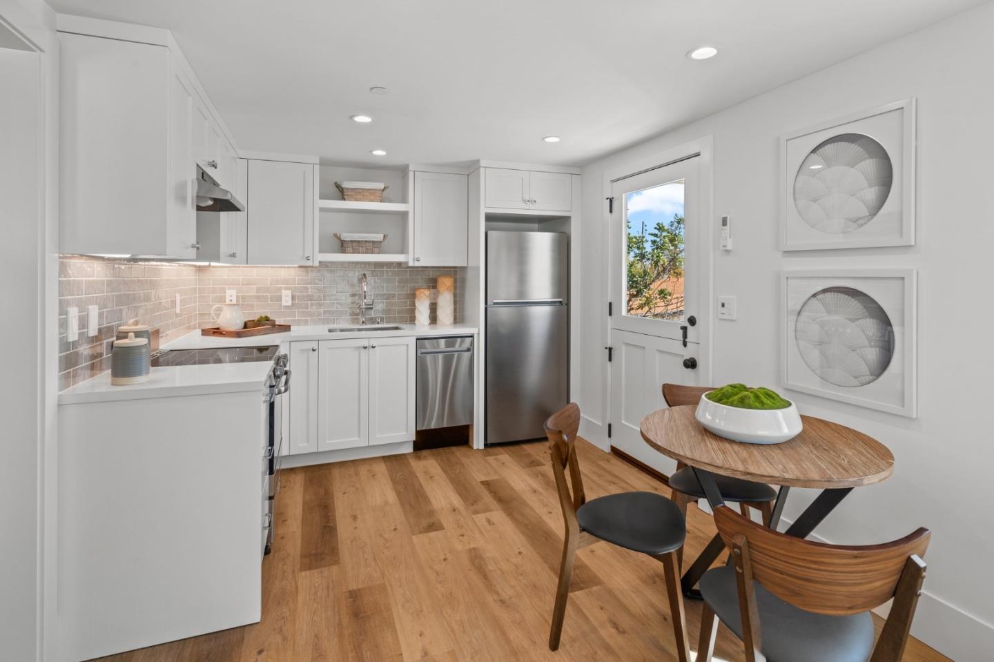 2108 Cully Place San Jose, CA 95124 - Photo 27 of 35 a kitchen with granite countertop a table chairs stove and wooden floor
