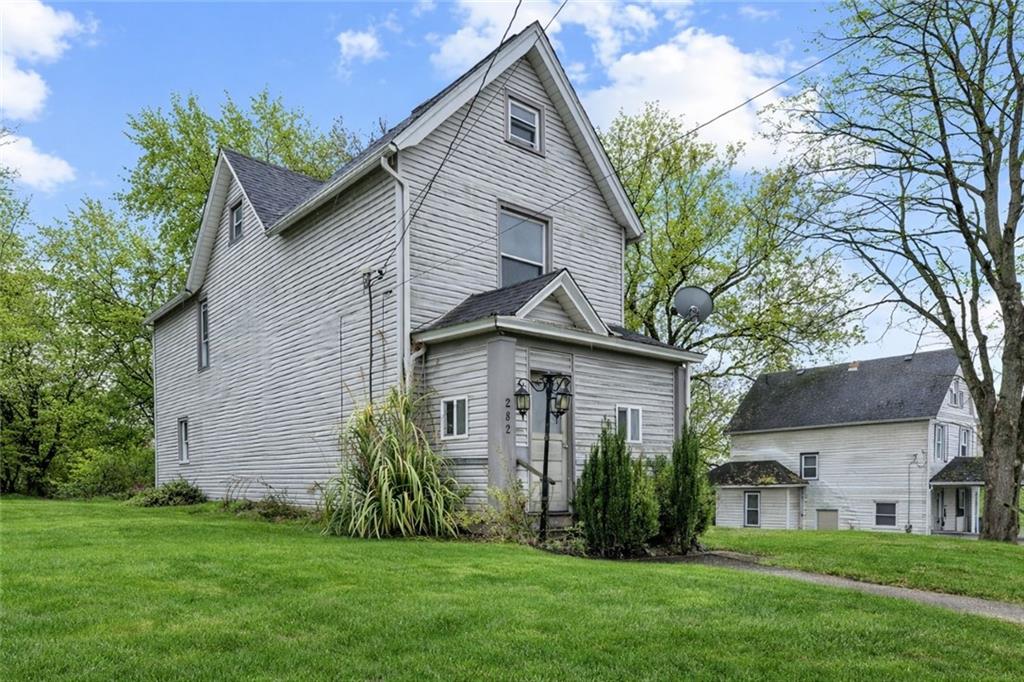 282 Orchard Street Sharon, PA 16146 - Photo 1 of 16 a front view of a house with a garden and yard