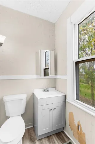 a bathroom with a toilet sink and mirror