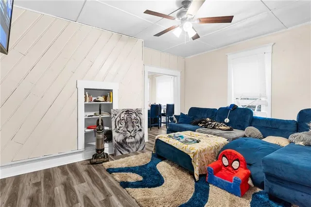 a living room with furniture a rug and white walls
