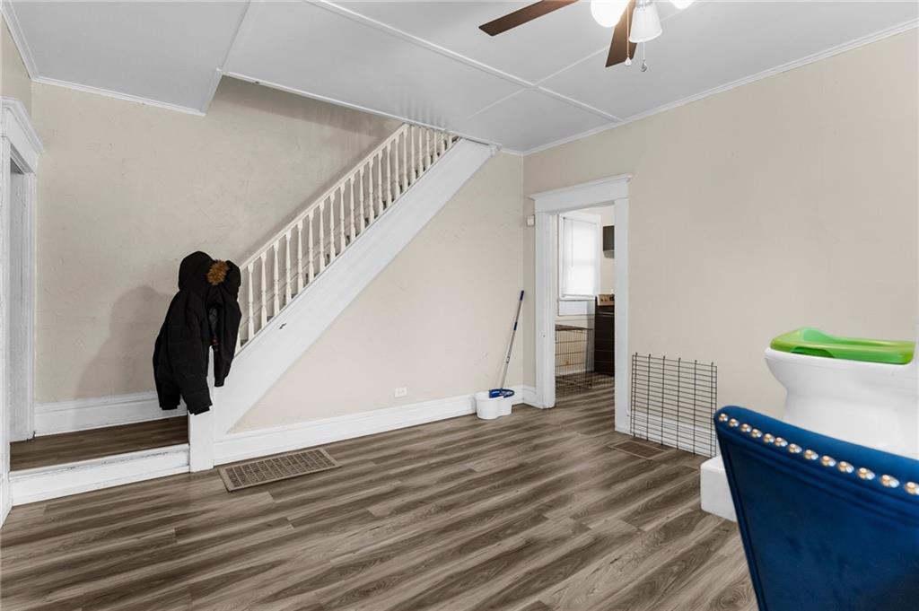 282 Orchard Street Sharon, PA 16146 - Photo 3 of 16 a view of an empty room with wooden floor and stairs