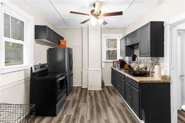 a kitchen with stainless steel appliances a stove refrigerator and microwave