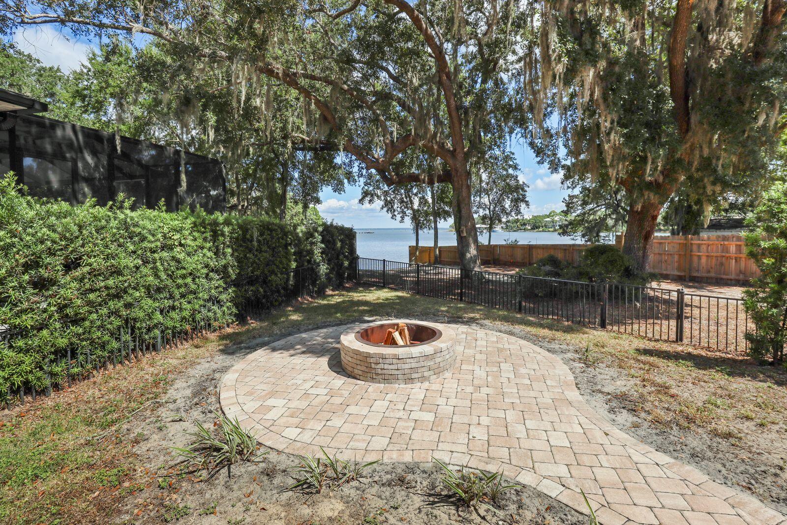 159 Beacon Point Drive Santa Rosa Beach, FL 32459 - Photo 23 of 57 a backyard of a house with fire pit and outdoor seating