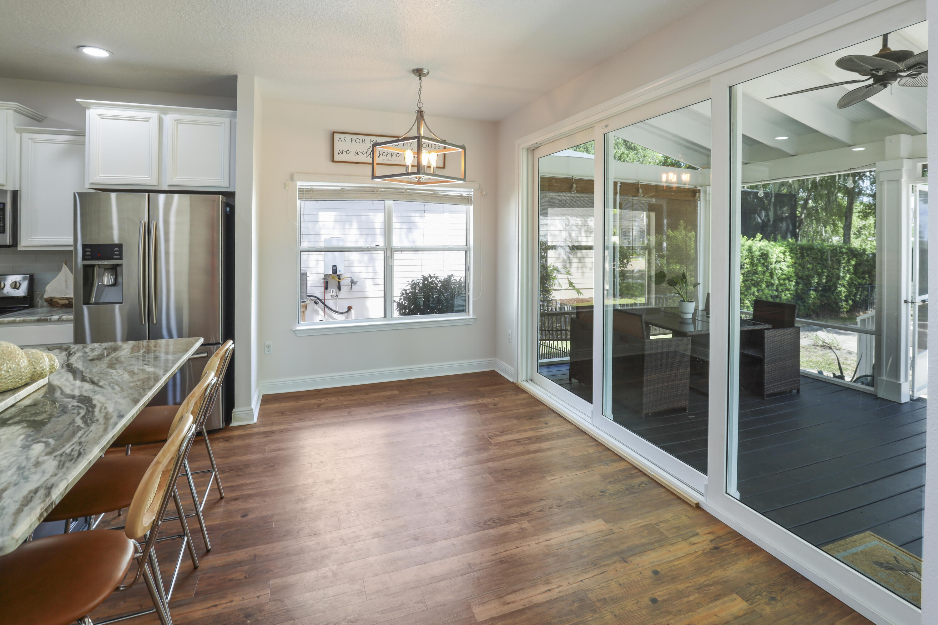 159 Beacon Point Drive Santa Rosa Beach, FL 32459 - Photo 38 of 57 a view of a room with kitchen island wooden floor and a refrigerator