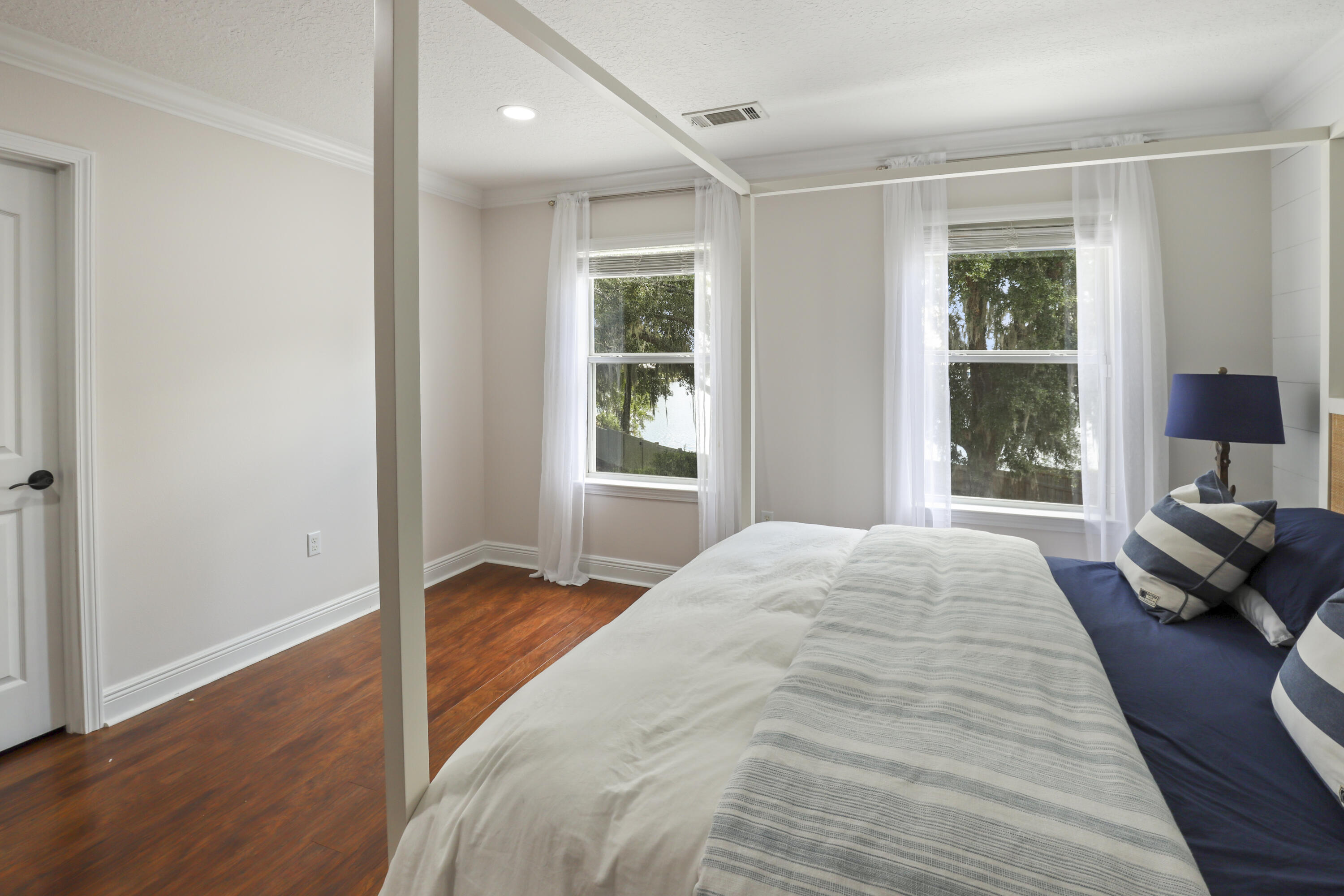 159 Beacon Point Drive Santa Rosa Beach, FL 32459 - Photo 44 of 57 a bedroom with a bed and wooden floor