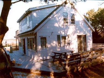 165 Indian Neck Road Wellfleet, MA 02667 - Photo 1 of 1 a front view of house with yard outdoor seating and barbeque oven