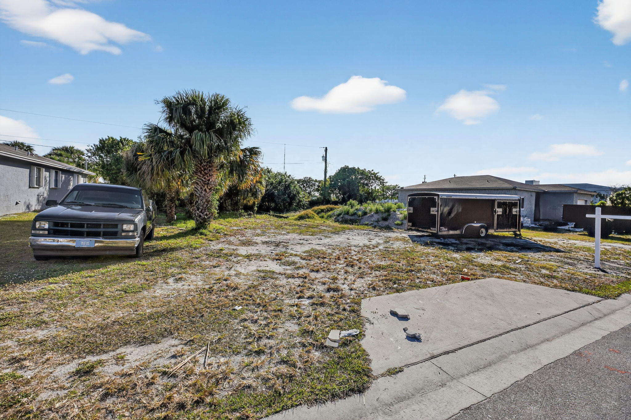 0 West 6th Street Riviera Beach, FL 33404 - Photo 2 of 8 a front view of a house with a garden