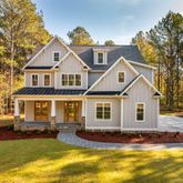a front view of a house with swimming pool and porch
