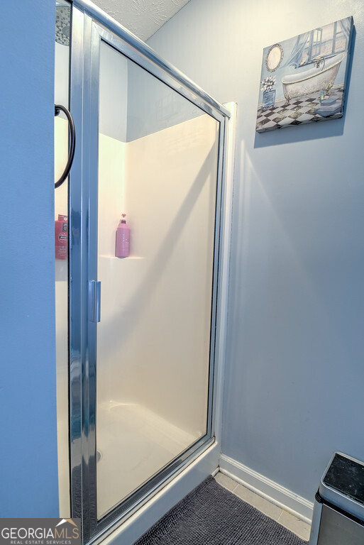 1513 Pointe S Circle Bethlehem, GA 30620 - Photo 11 of 22 a bathroom with a glass shower door