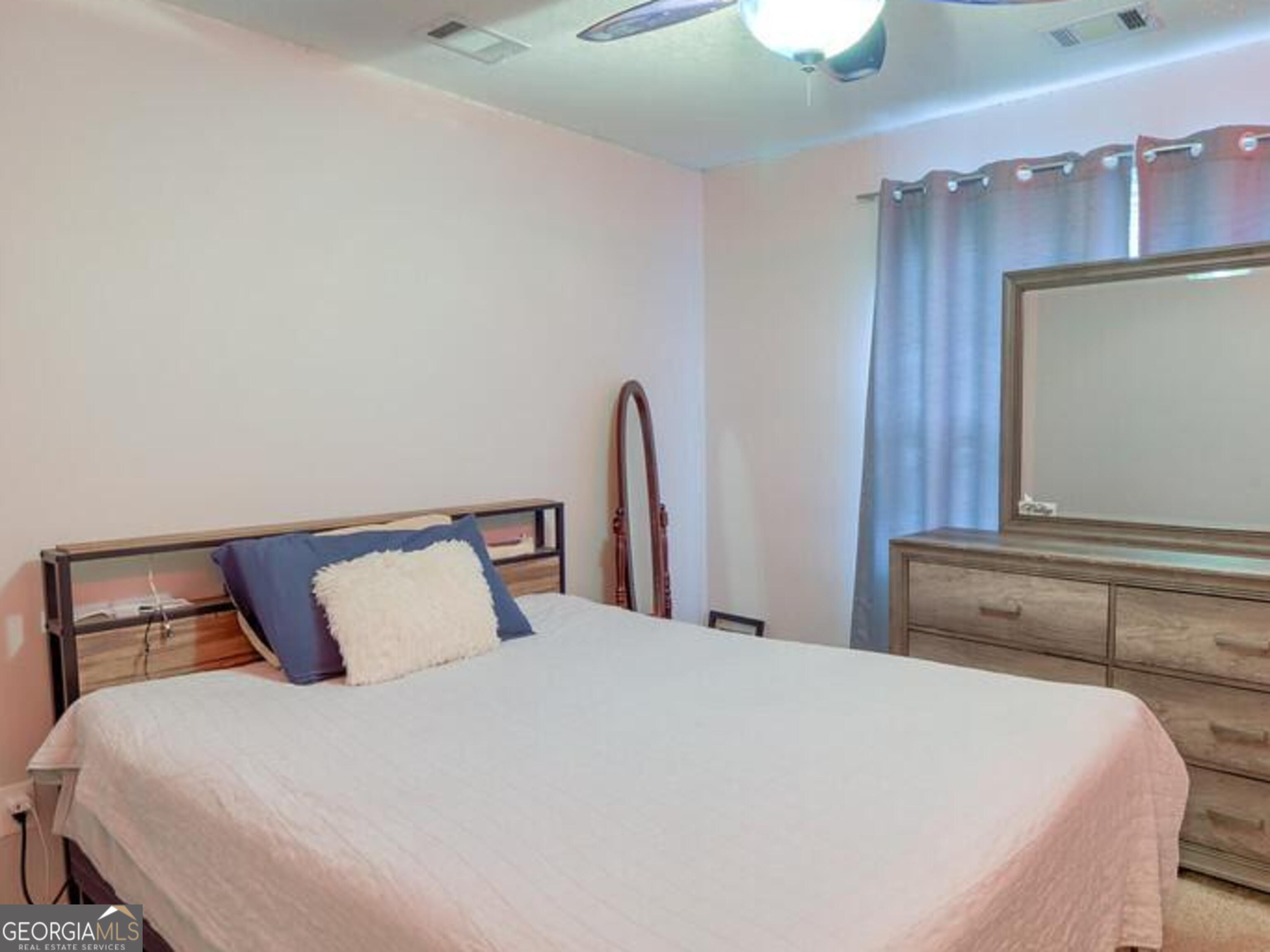 1513 Pointe S Circle Bethlehem, GA 30620 - Photo 14 of 22 a bedroom with a bed and two lamp