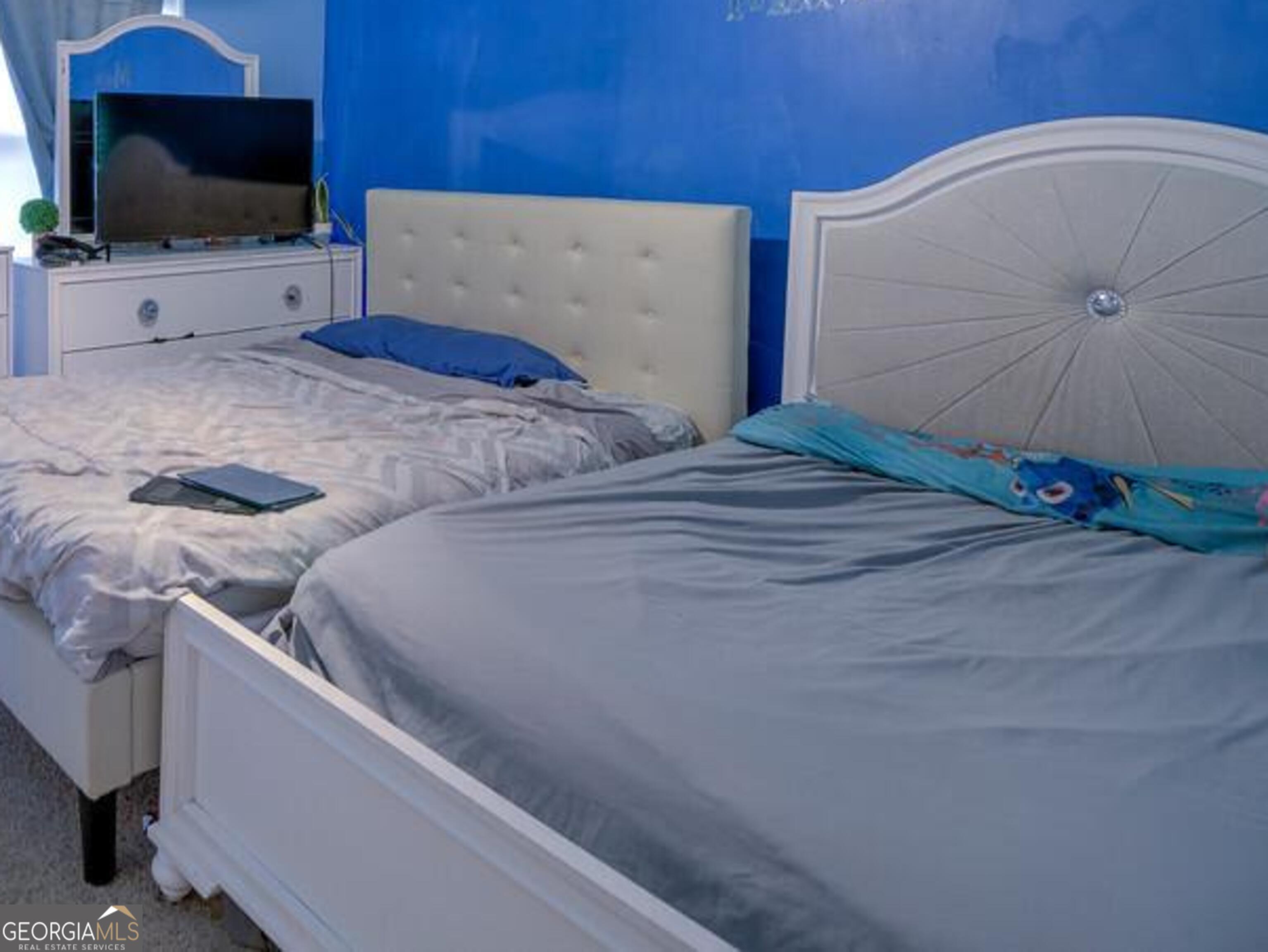 1513 Pointe S Circle Bethlehem, GA 30620 - Photo 15 of 22 a bedroom with a bed and a flat screen tv