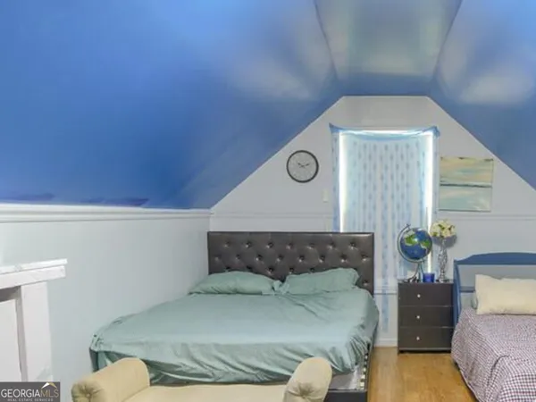a bed sitting in a bedroom next to a window