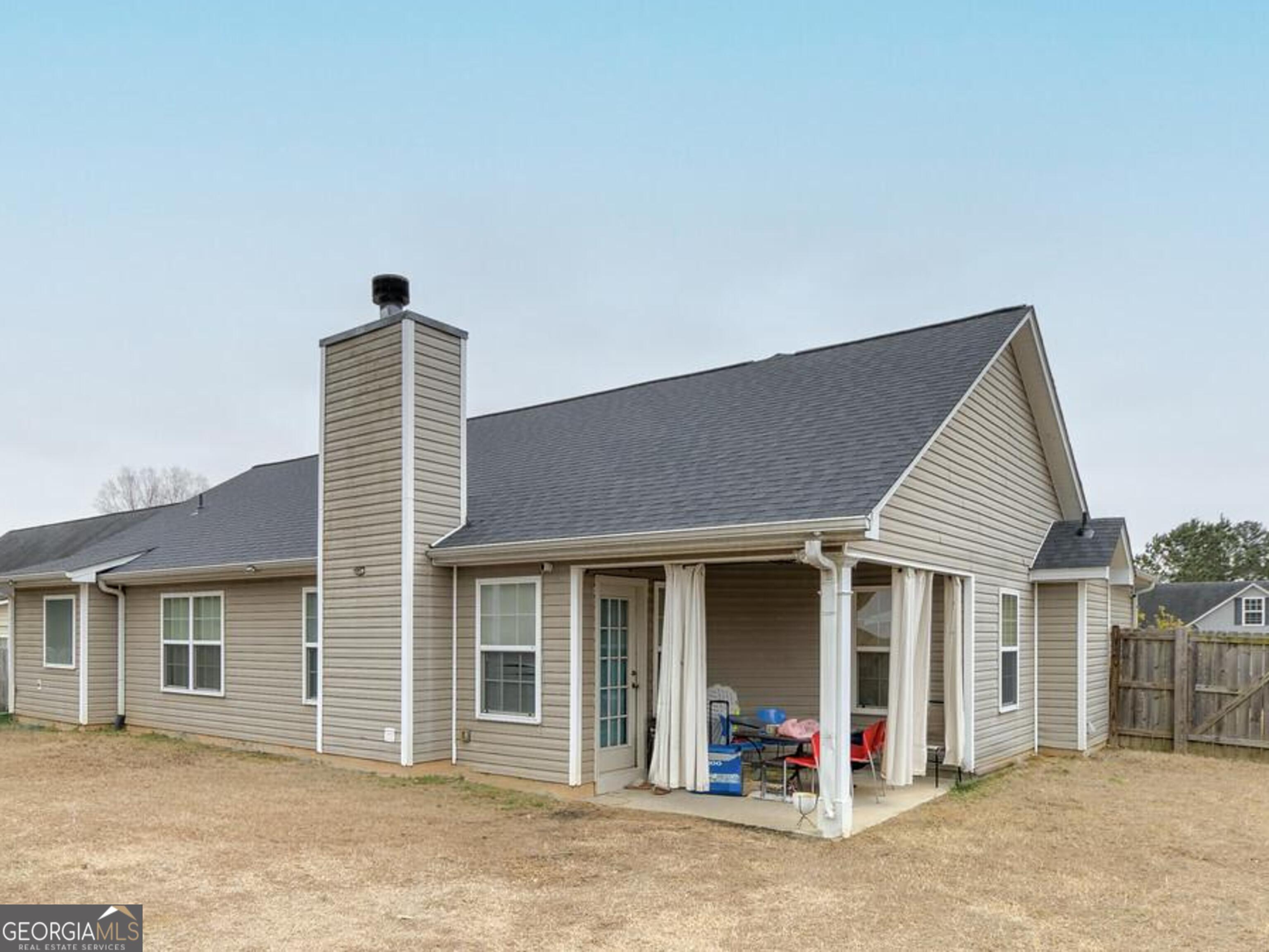 1513 Pointe S Circle Bethlehem, GA 30620 - Photo 19 of 22 a front view of a house with a barbeque and wooden fence