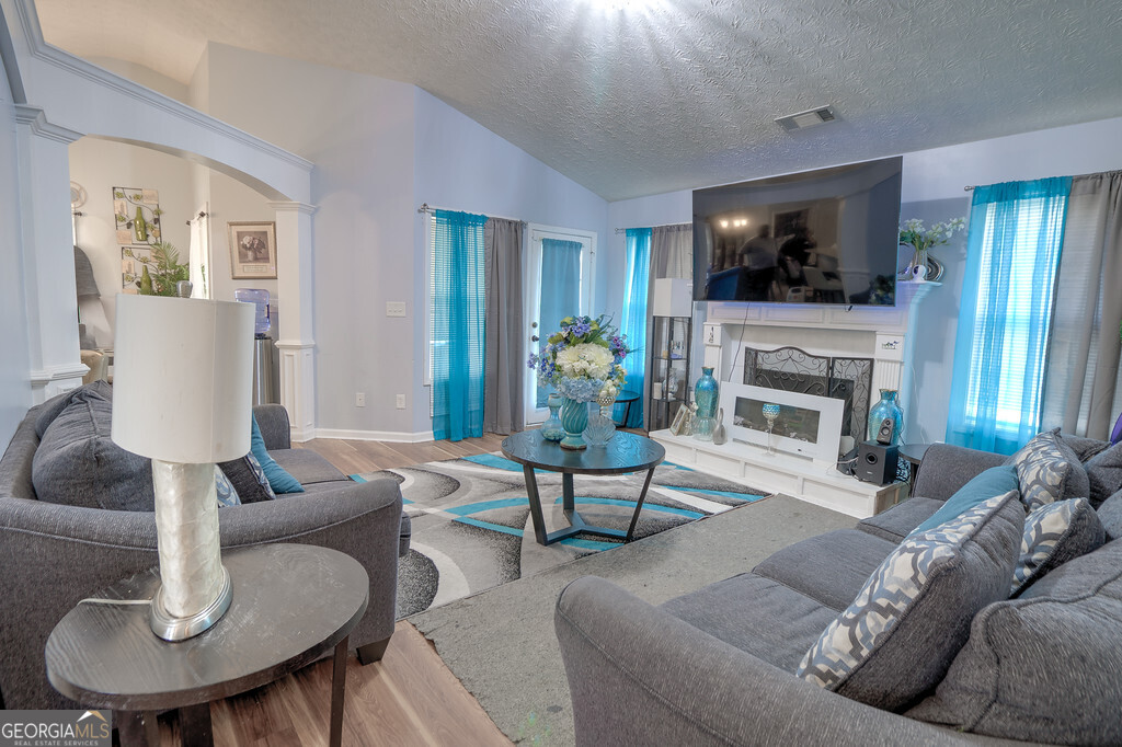 1513 Pointe S Circle Bethlehem, GA 30620 - Photo 4 of 22 a living room with furniture a fireplace and a flat screen tv