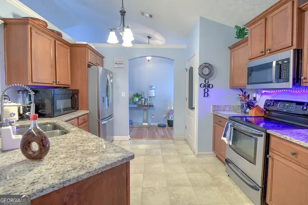 a kitchen with a sink stove and refrigerator