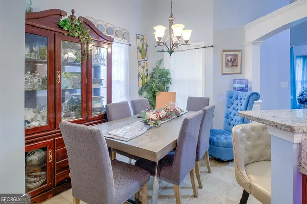 a view of a dining room with furniture wooden floor and chandelier