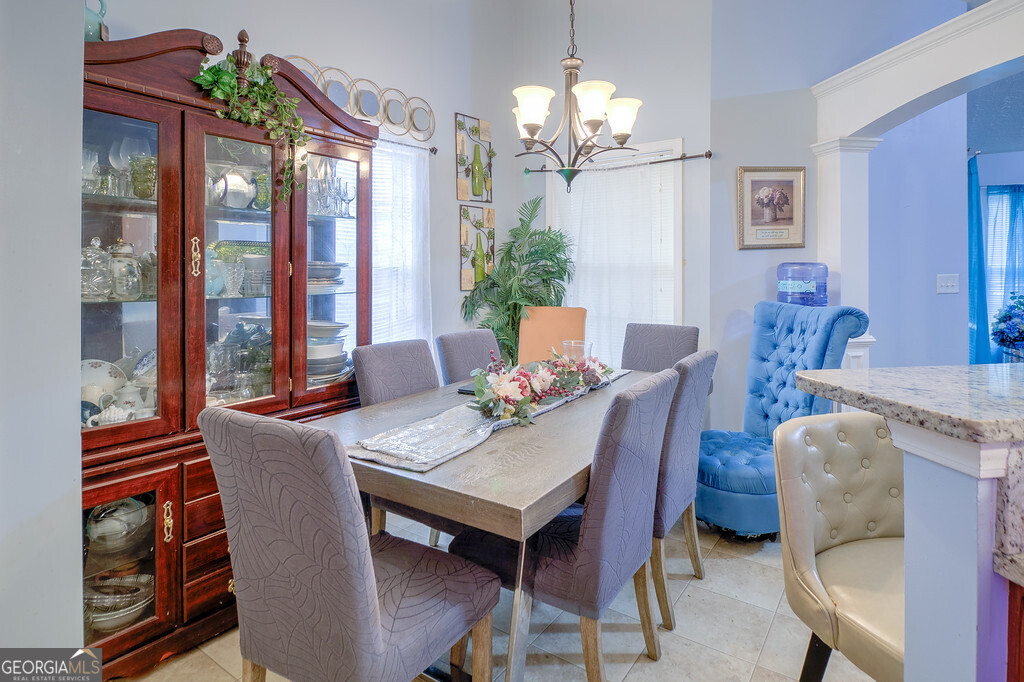 1513 Pointe S Circle Bethlehem, GA 30620 - Photo 8 of 22 a view of a dining room with furniture wooden floor and chandelier