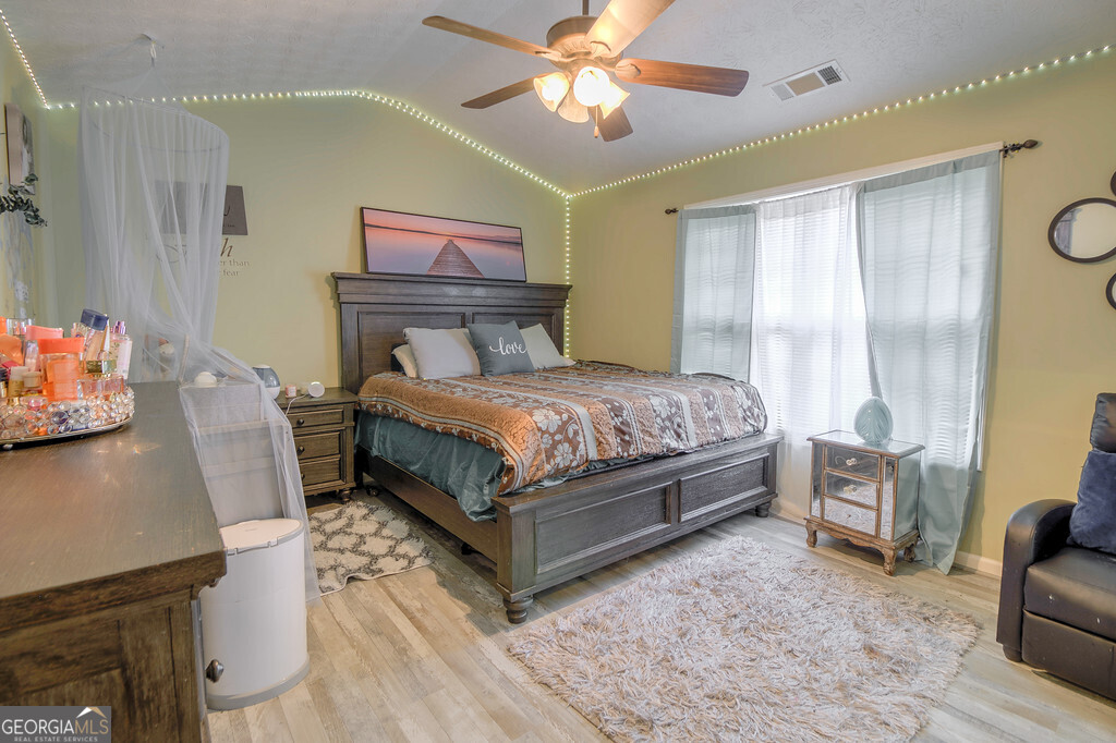 1513 Pointe S Circle Bethlehem, GA 30620 - Photo 10 of 22 a bedroom with a bed and a chandelier